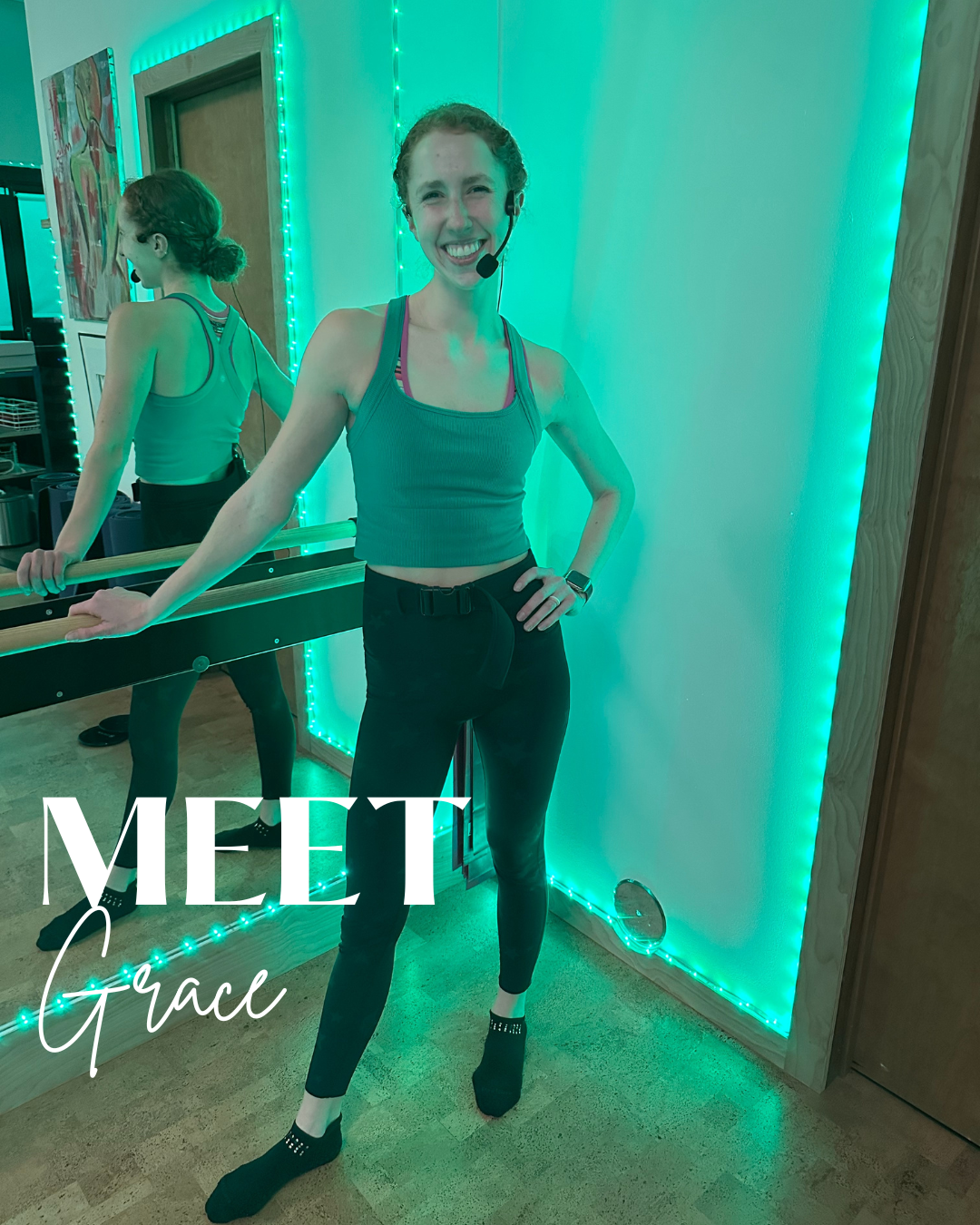 A woman with curly hair wearing a headset, a teal sports bra, and black leggings is smiling and standing in a room with green LED lights on the walls. She is posing with one hand on her hip while holding onto a ballet barre. There is a mirror reflecting her back. The photo has the text 'MEET Grace' overlaid.
