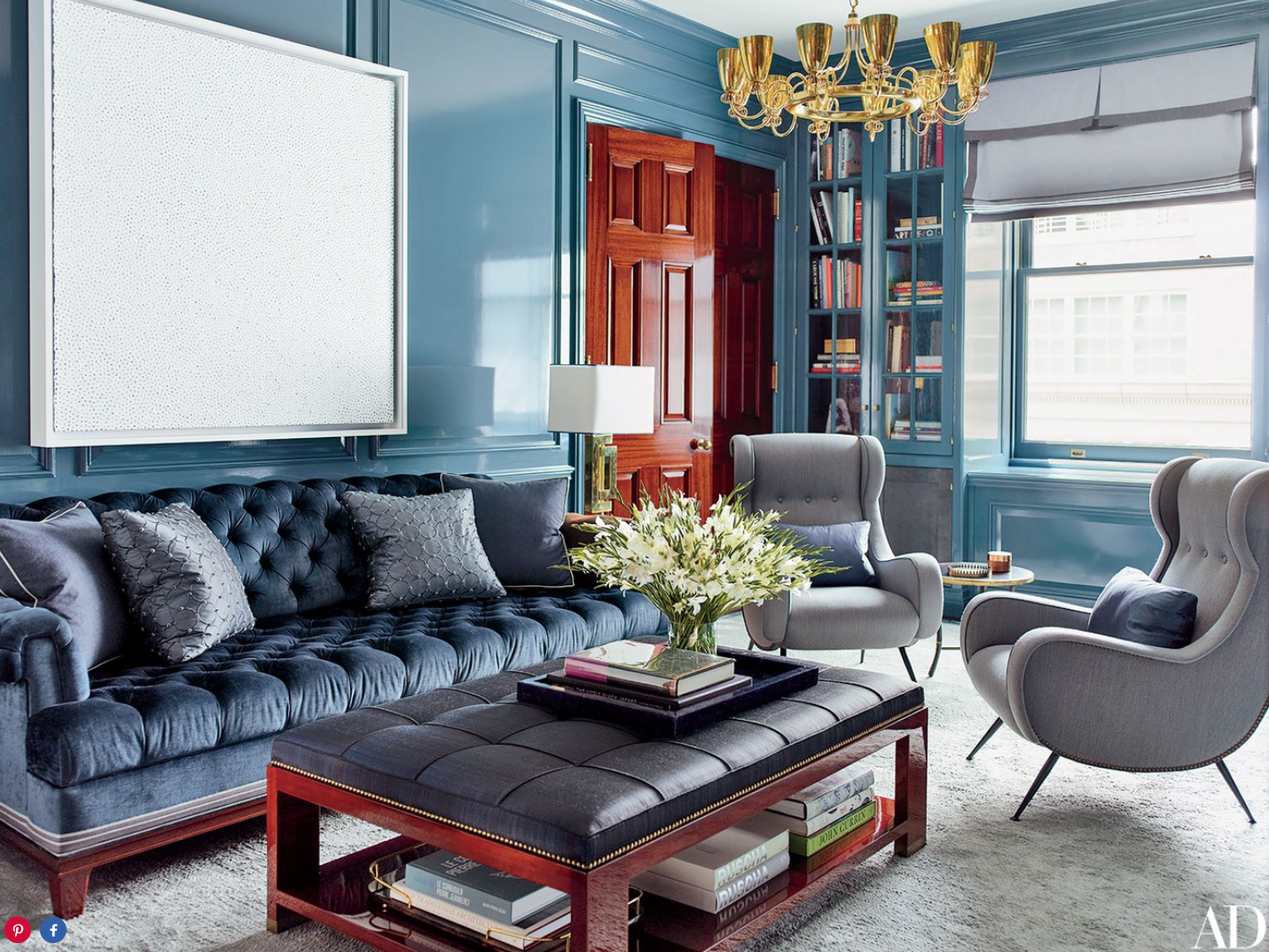  Walls painted in a Sherwin-Williams high-gloss oil serve as the backdrop for a Yayoi Kusama canvas in the library; the sofa is upholstered in a Robert Allen velvet, and the armchairs are vintage Paolo Buffa designs. 
