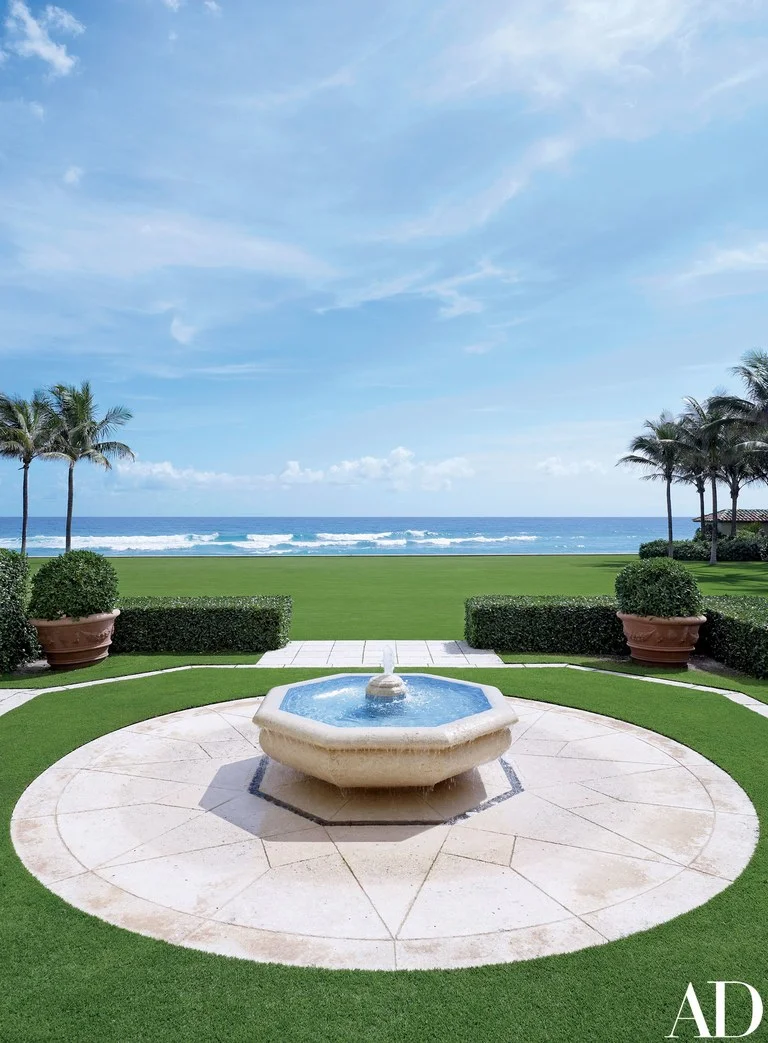 A fountain on the estate echoes the blue of the Atlantic Ocean beyond; the grounds were reenvisioned by Lang Design Group Landscape Architects.