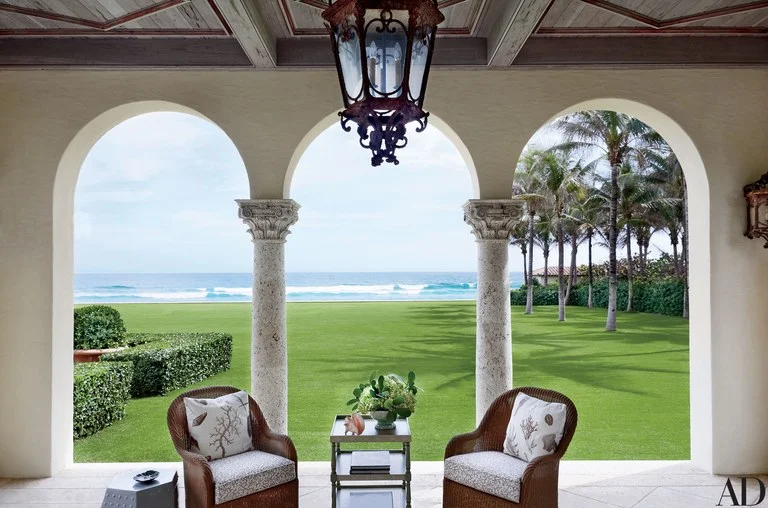 The library loggia is furnished with chairs cushioned in Clarence House fabrics.