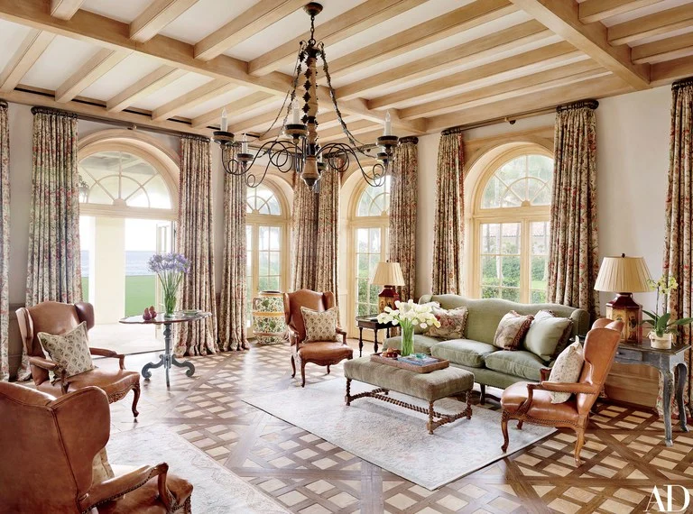In the family room, a Formations chandelier joins curtains made of a Lee Jofa print.