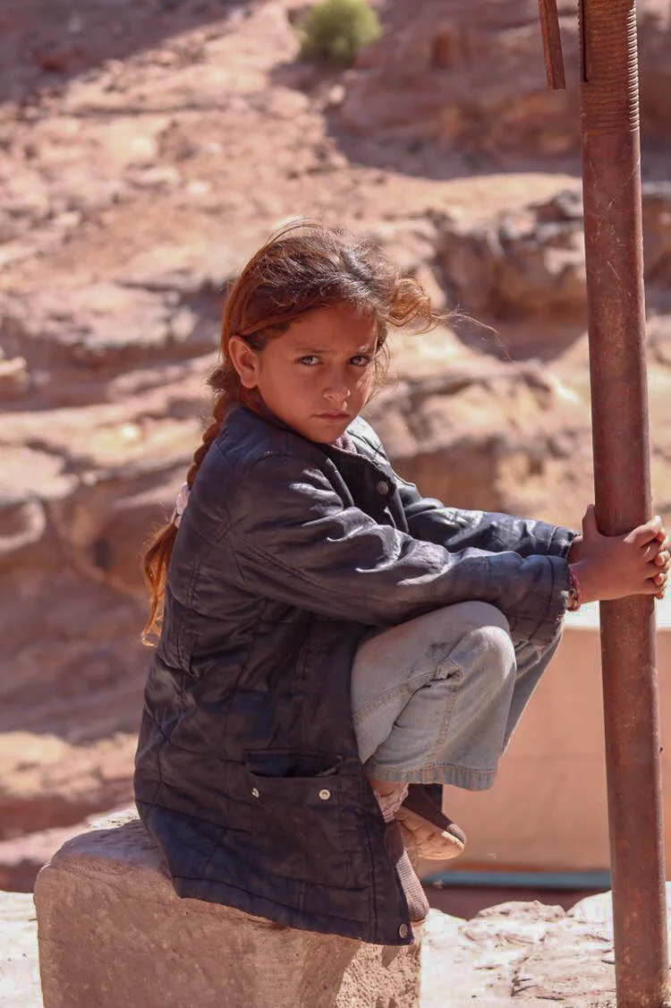 My friend Mia captured this image of a little bedouin girl. We had seen her all over Petra at every stop we made. How she scales those steep sandstone cliffs and hills so quickly with out skipping a beat is beyond me, but this is home for her, she i…