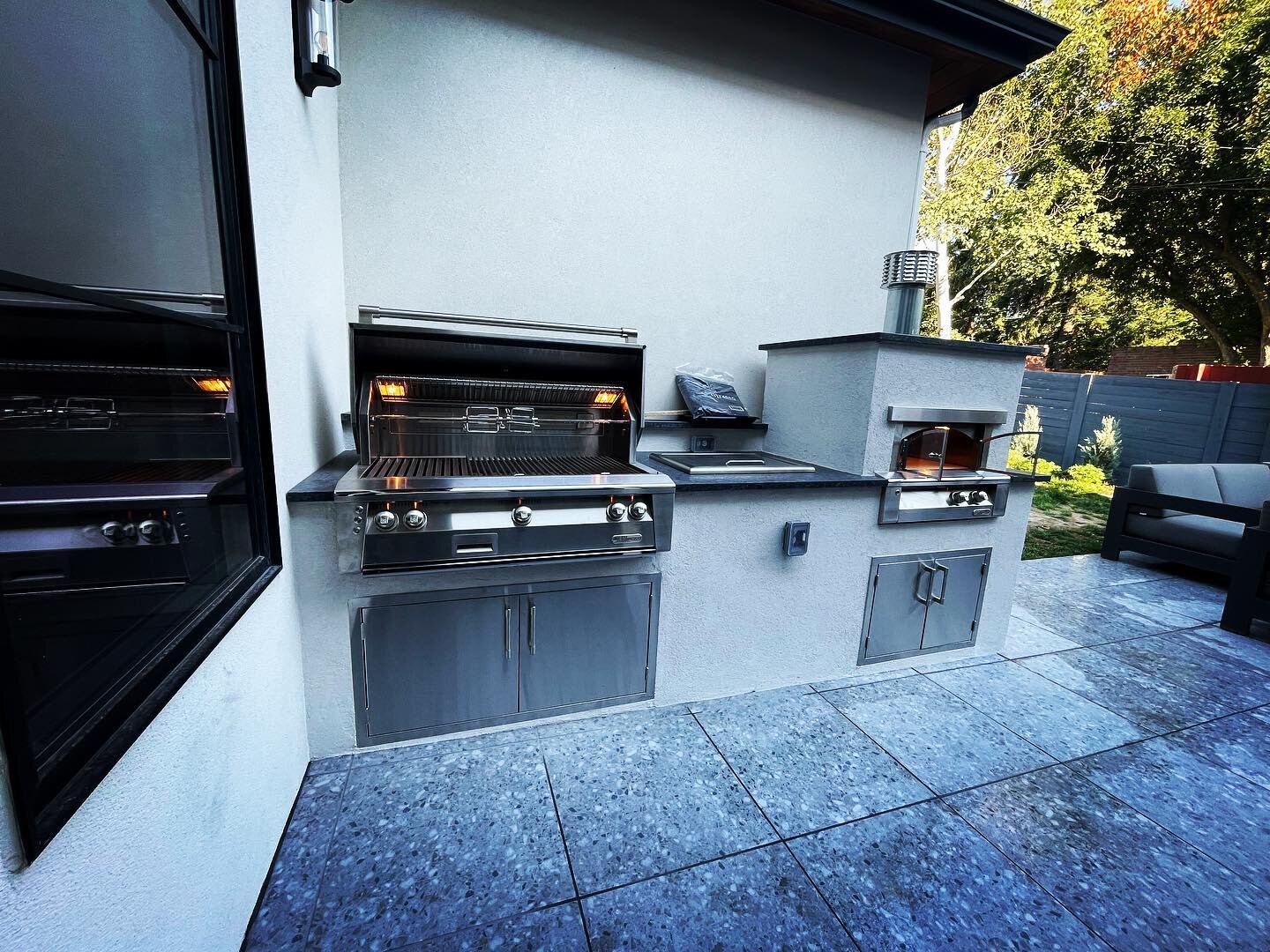 Absolutely love how this space came out!! We added the grill island and matched the stucco to the house so it blends perfectly!  Including a top of the line grill and pizza oven from @alfresco_grills.  We did a porcelain tile overlay to the patio to 