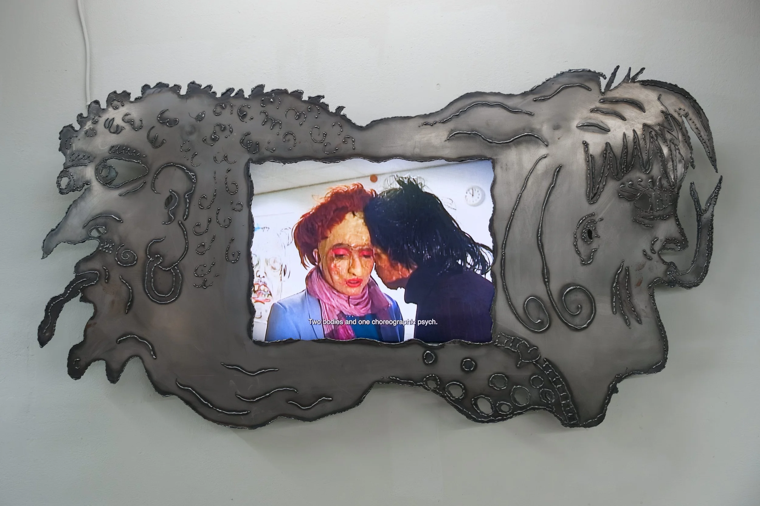  Siamese Others 2# (In collaboration with Elen Braga), 2026, multimedia video installation: welded line drawing on steel, 15:40 minutes, 140 x 74 cm 