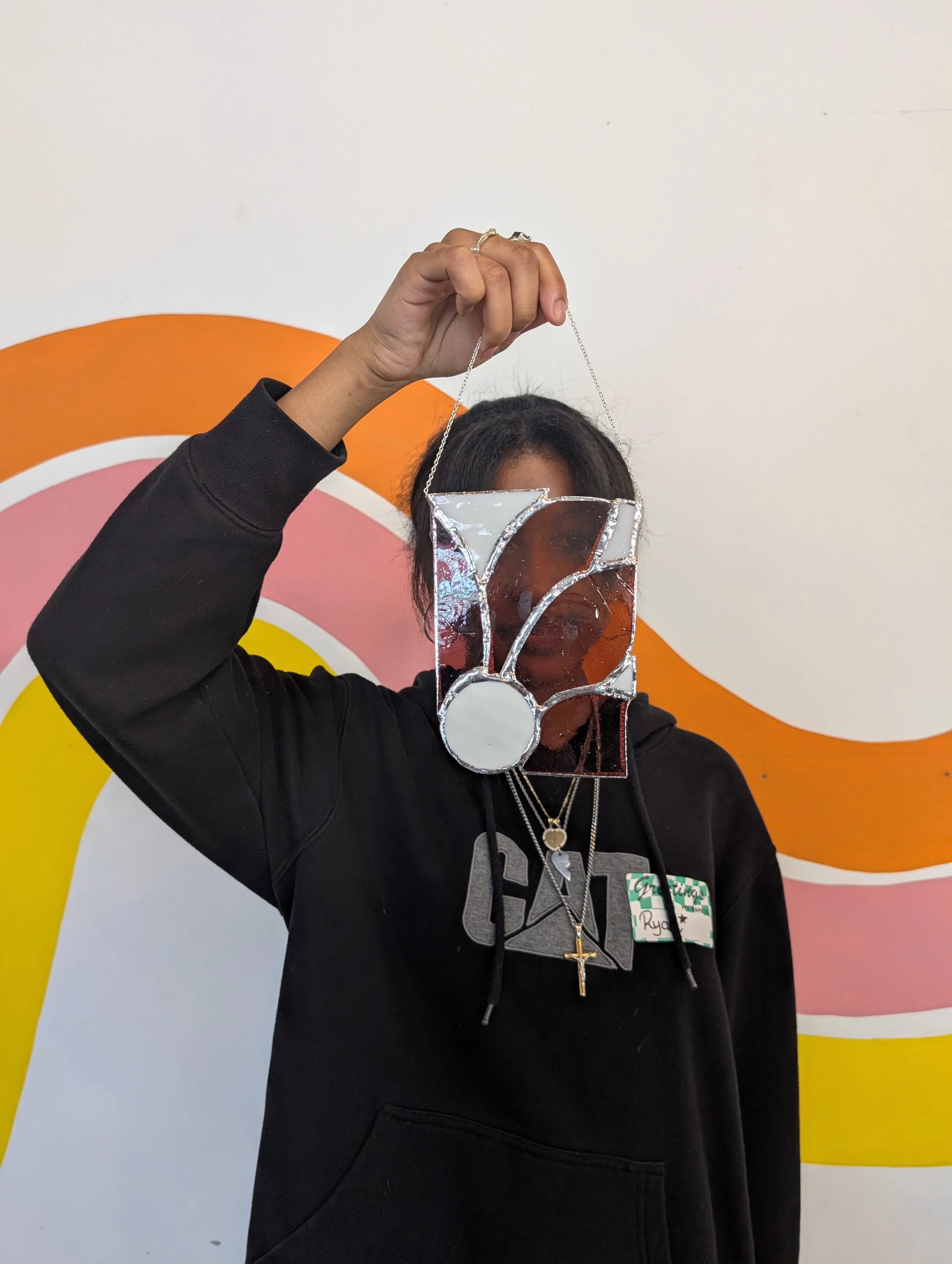 Student with their stained glass artwork after our visit to Element Art Center, 2025