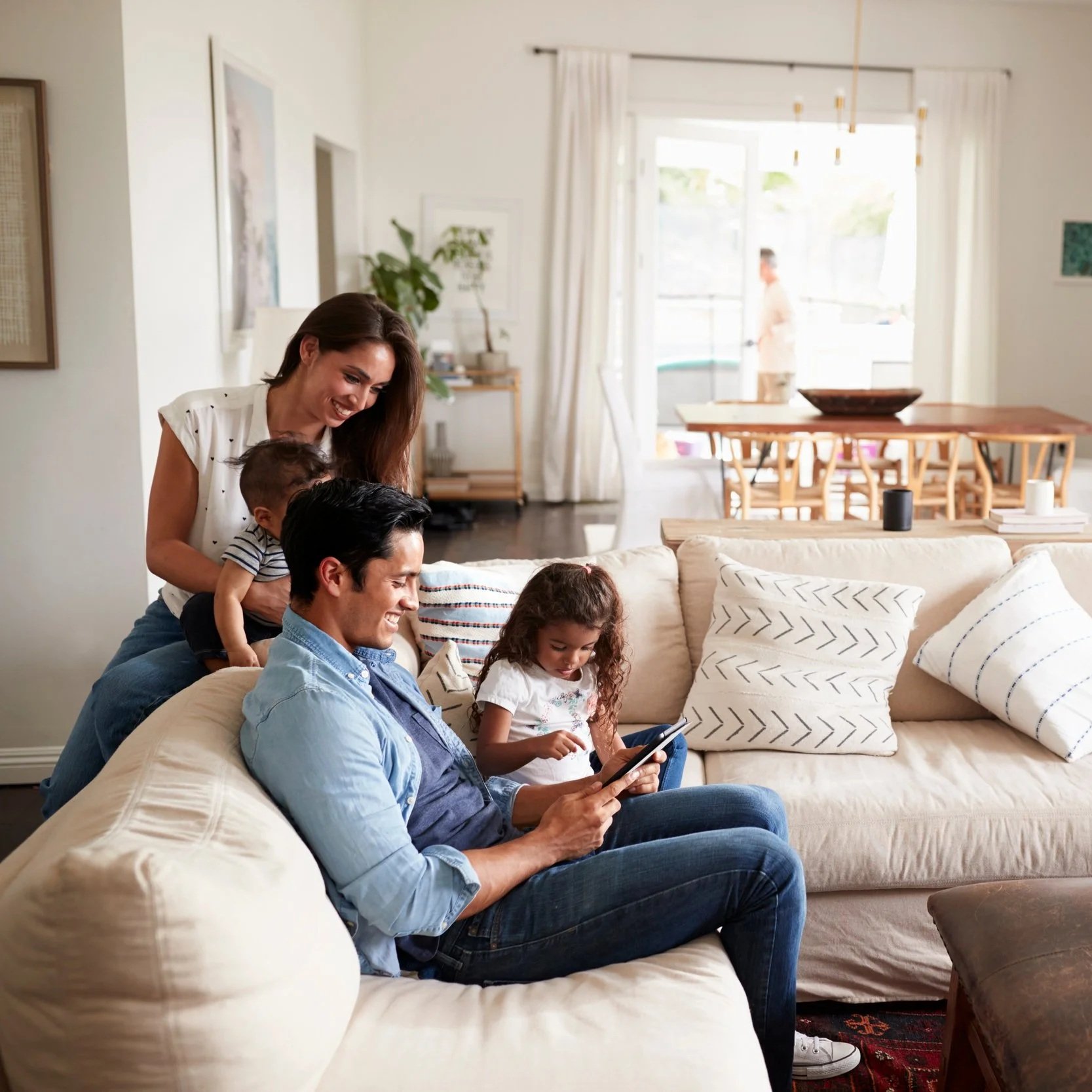 Family spending time together in living room knowing they have homeowners insurance thanks to Gerald Bailey Insurance