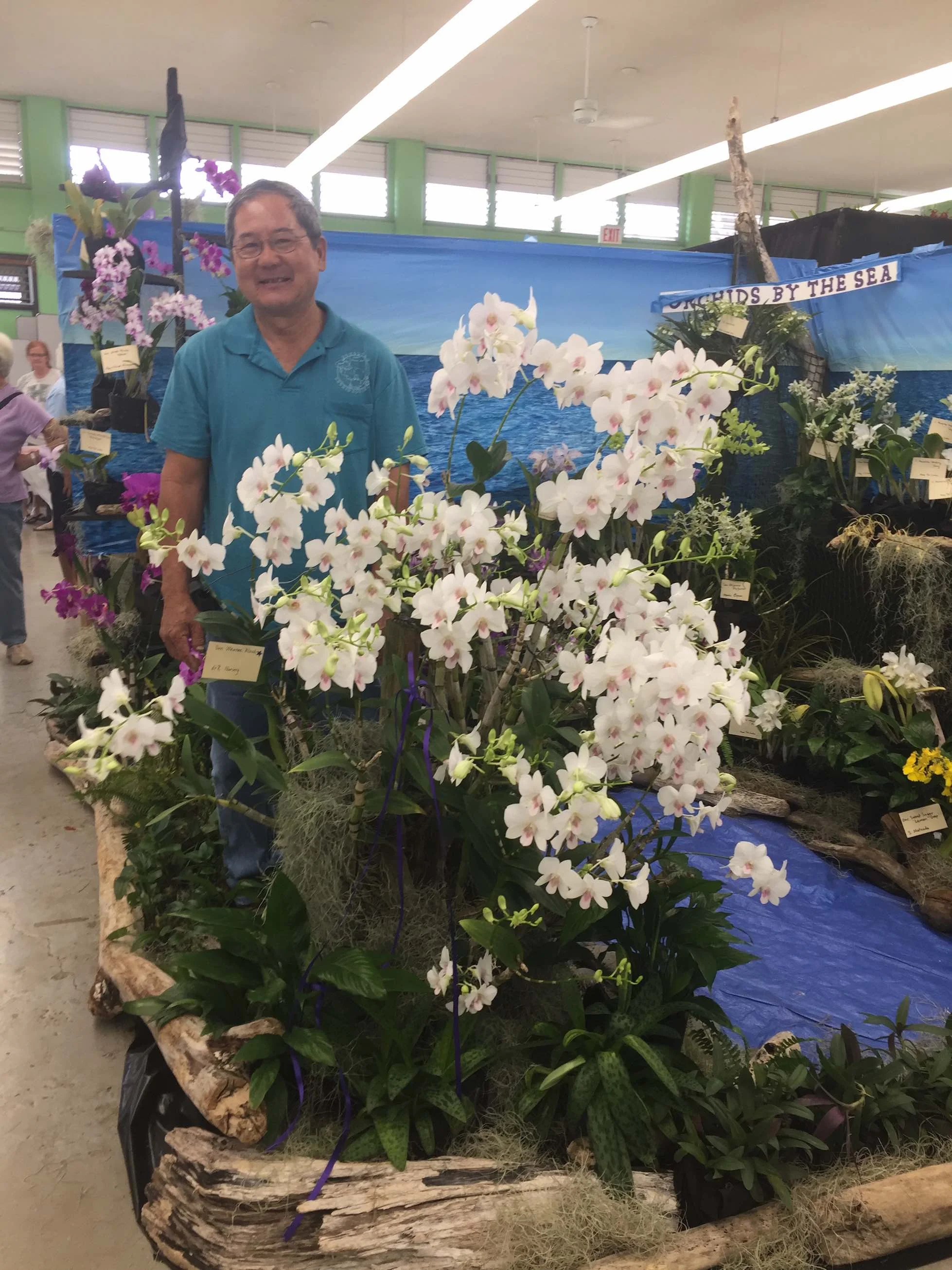 Roy Tokunaga with his four-time Best In Show orchid (Dendrobium Waianae Blush)