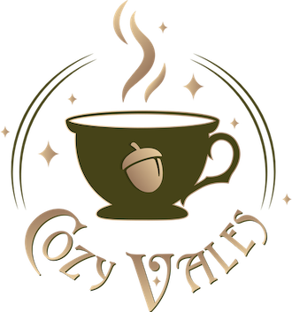 Cozy Vales logo - a mug decorated with an acorn.