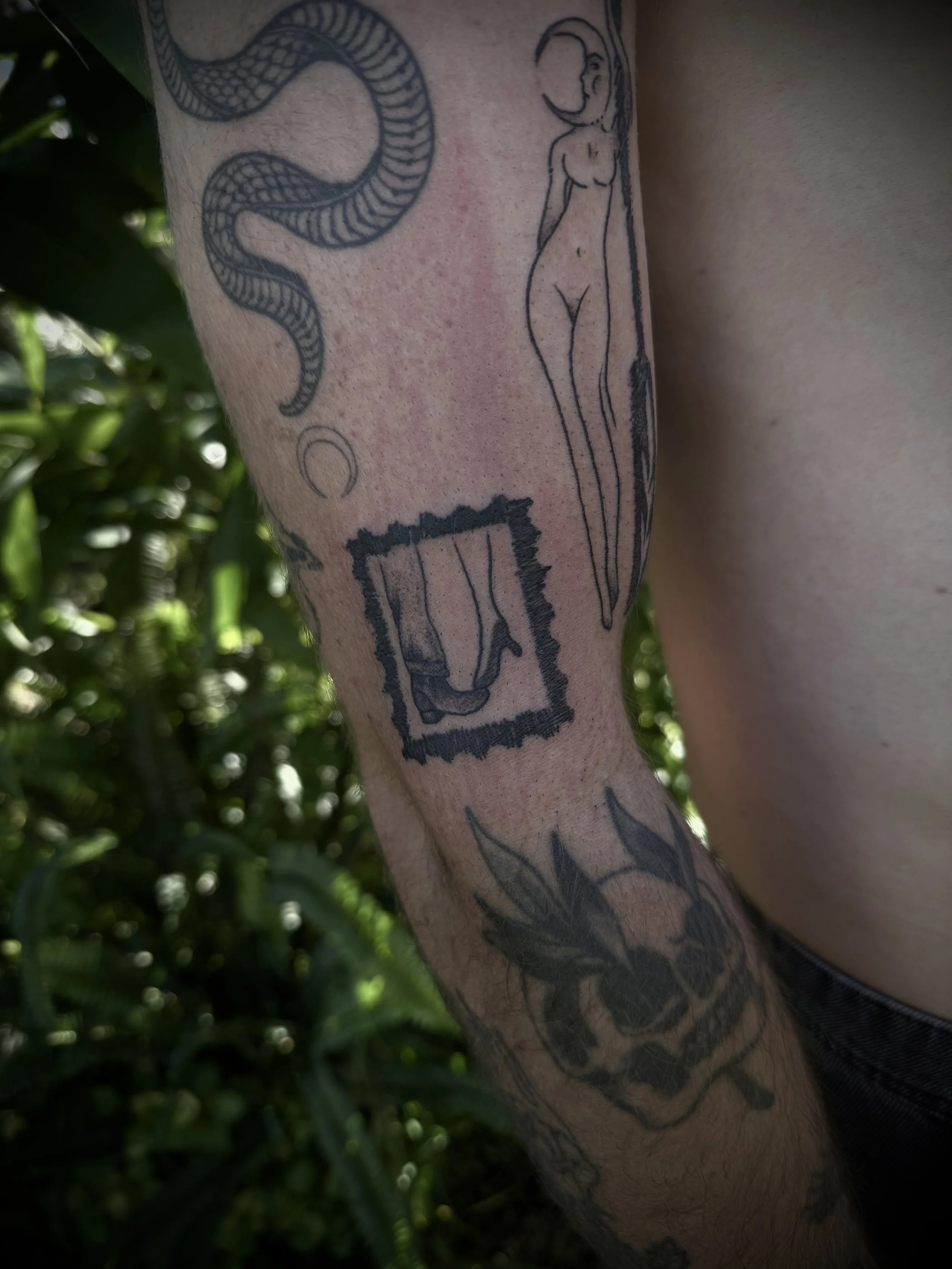 small black and grey stamp tattoo