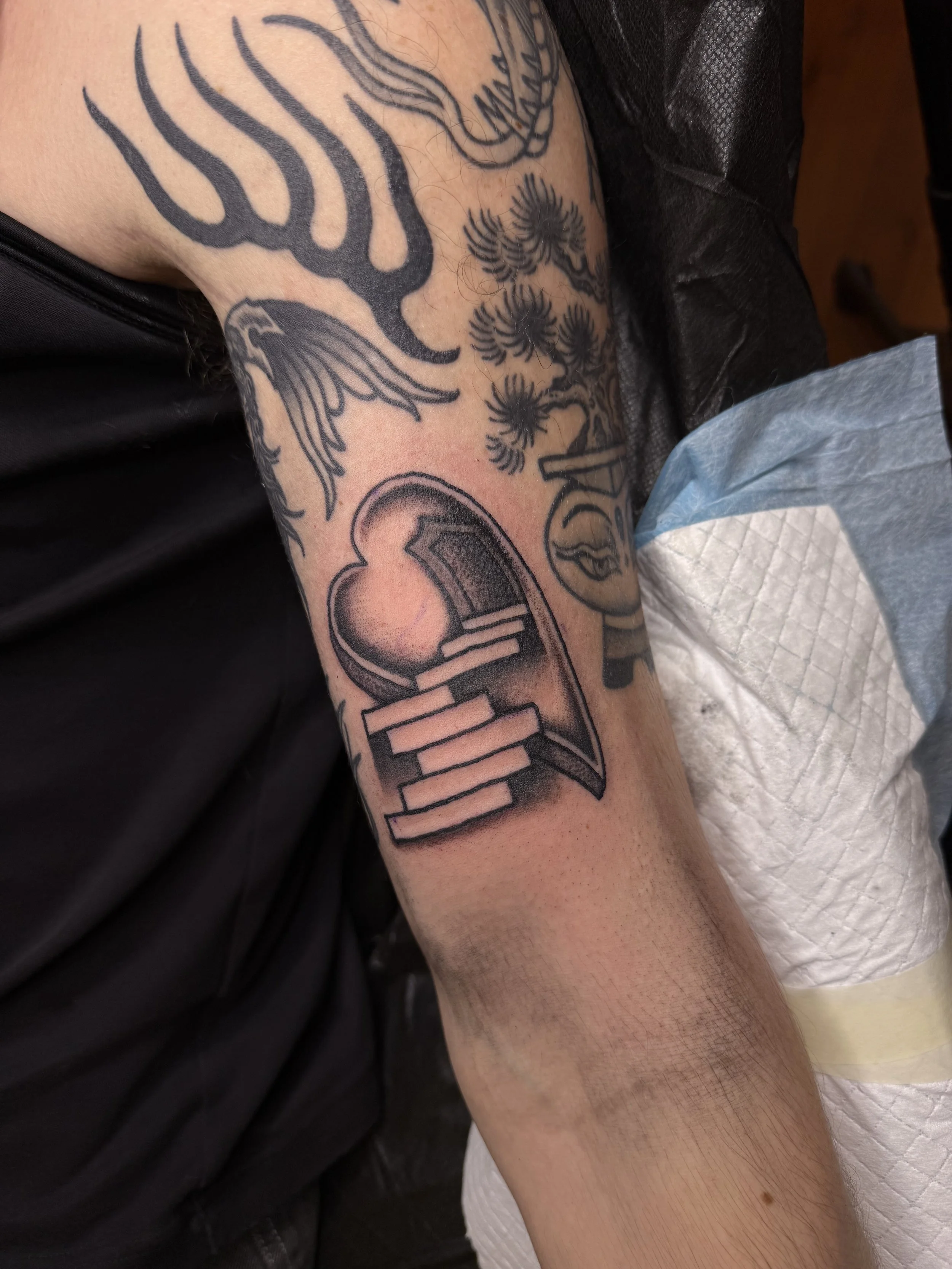 bold traditional heart tattoo upper arm