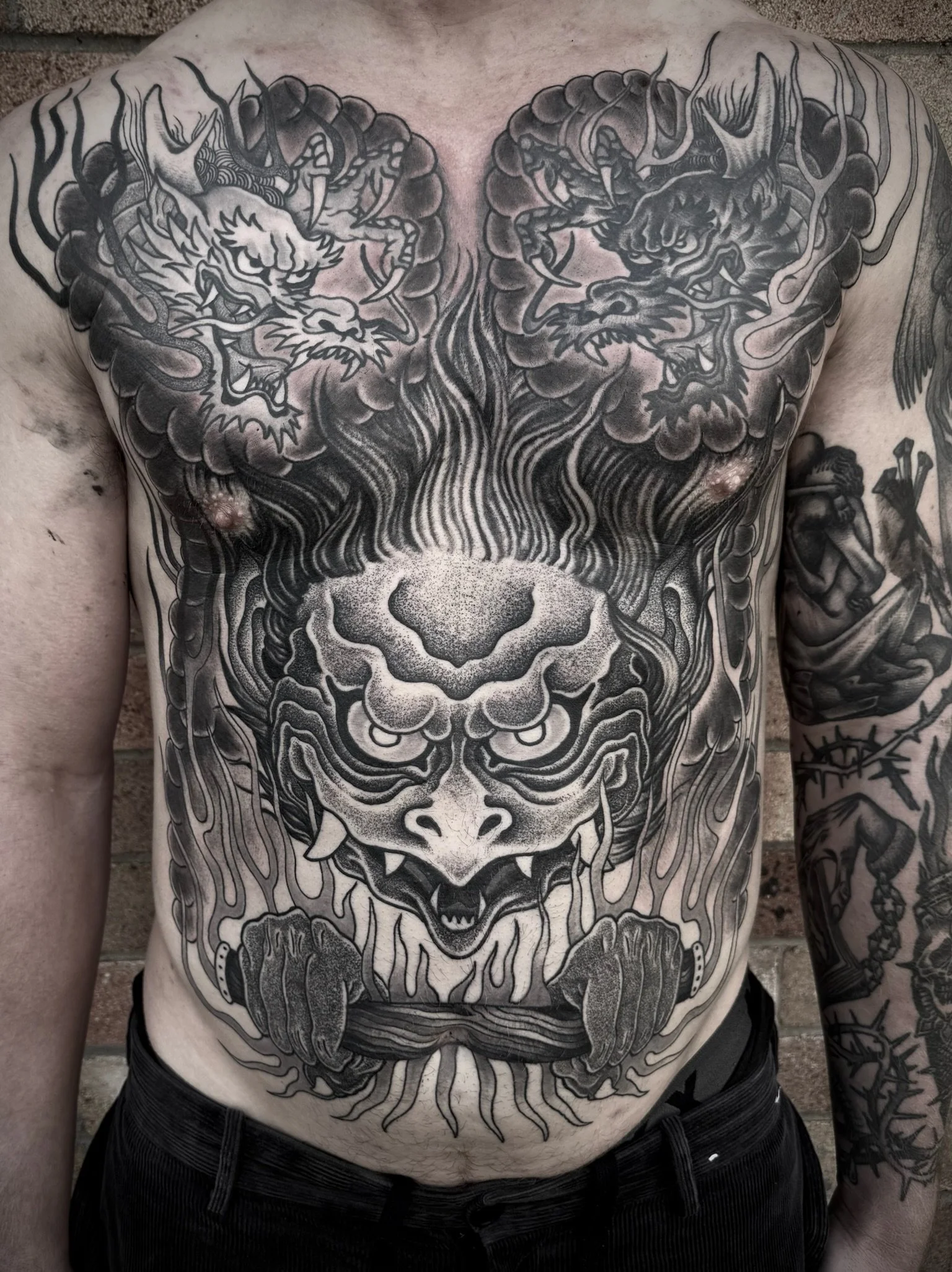 black traditional japanese black and grey chest and stomach tattoo