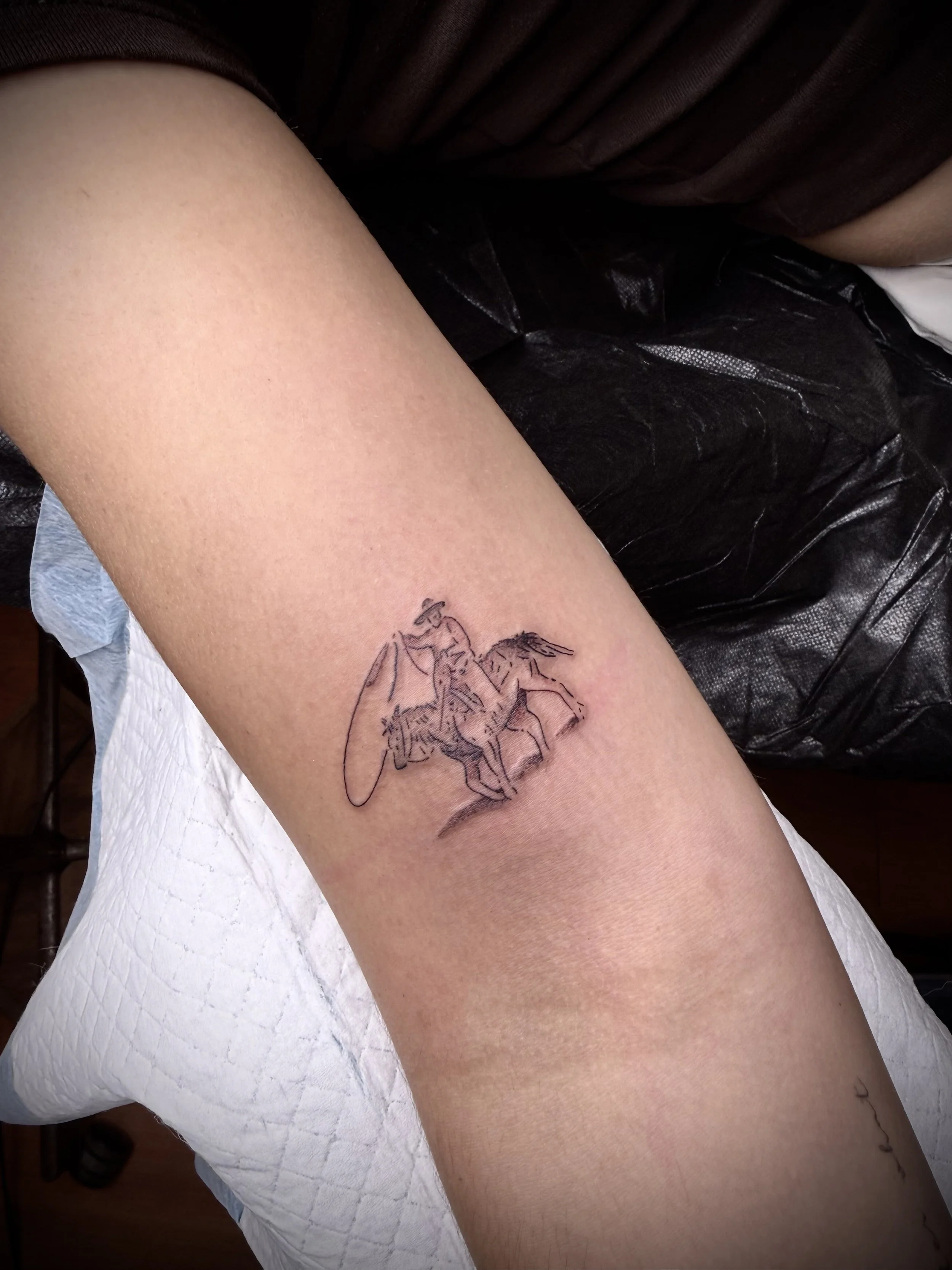 small fine line cowboy tattoo
