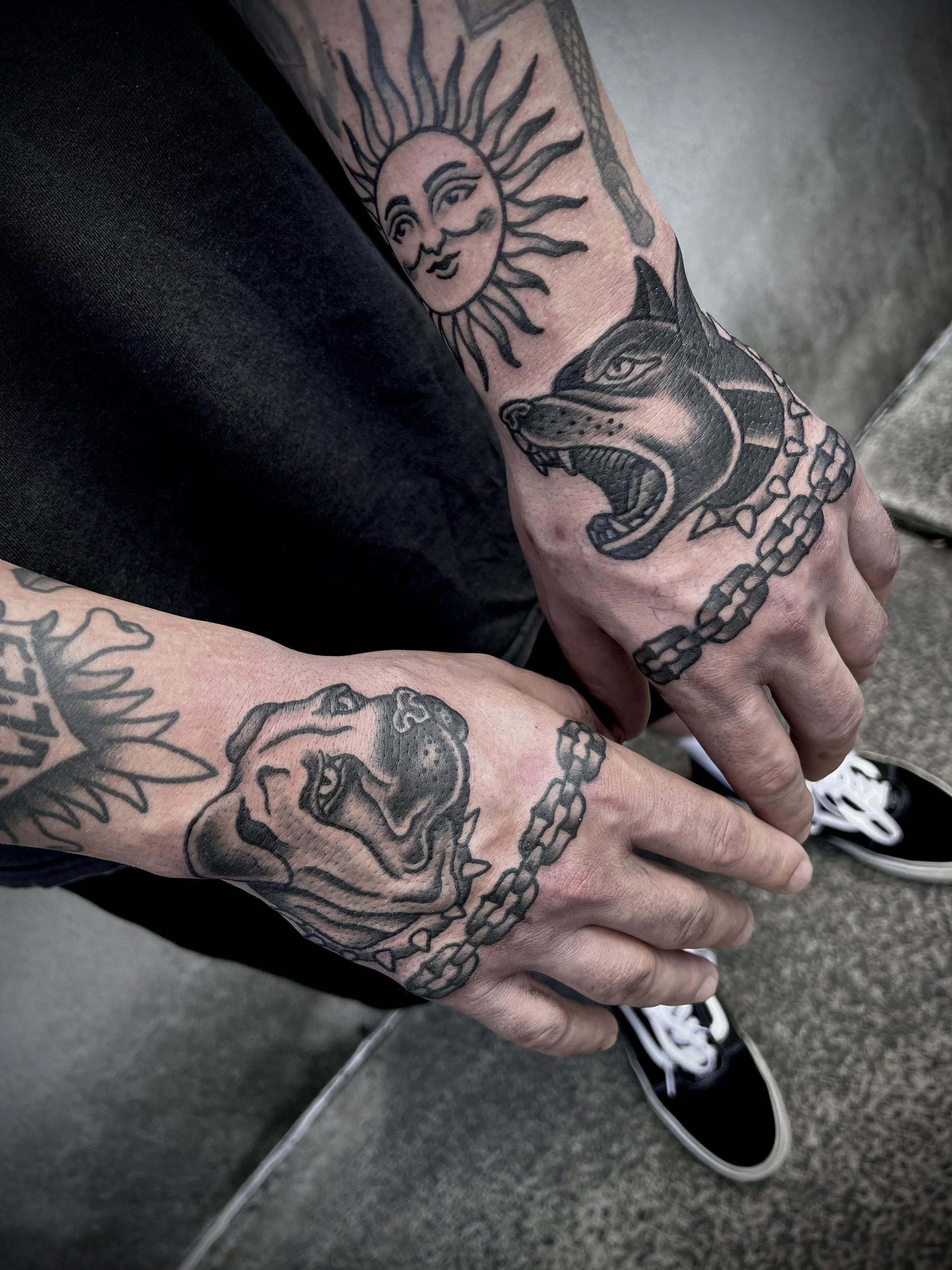 hand tattoos black and grey bold traditional dog portraits with chain links
