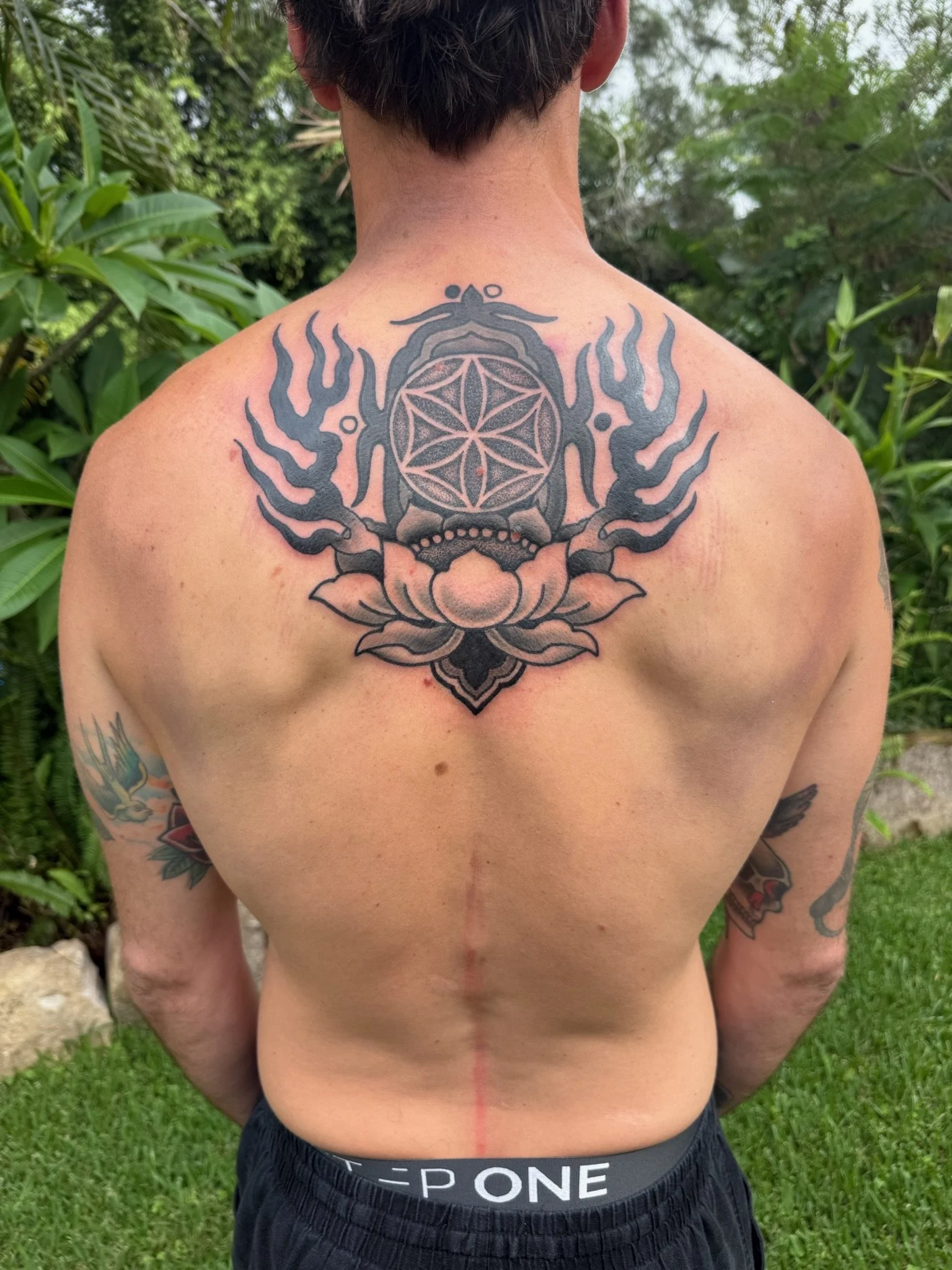 ornamental lotus flower back tattoo