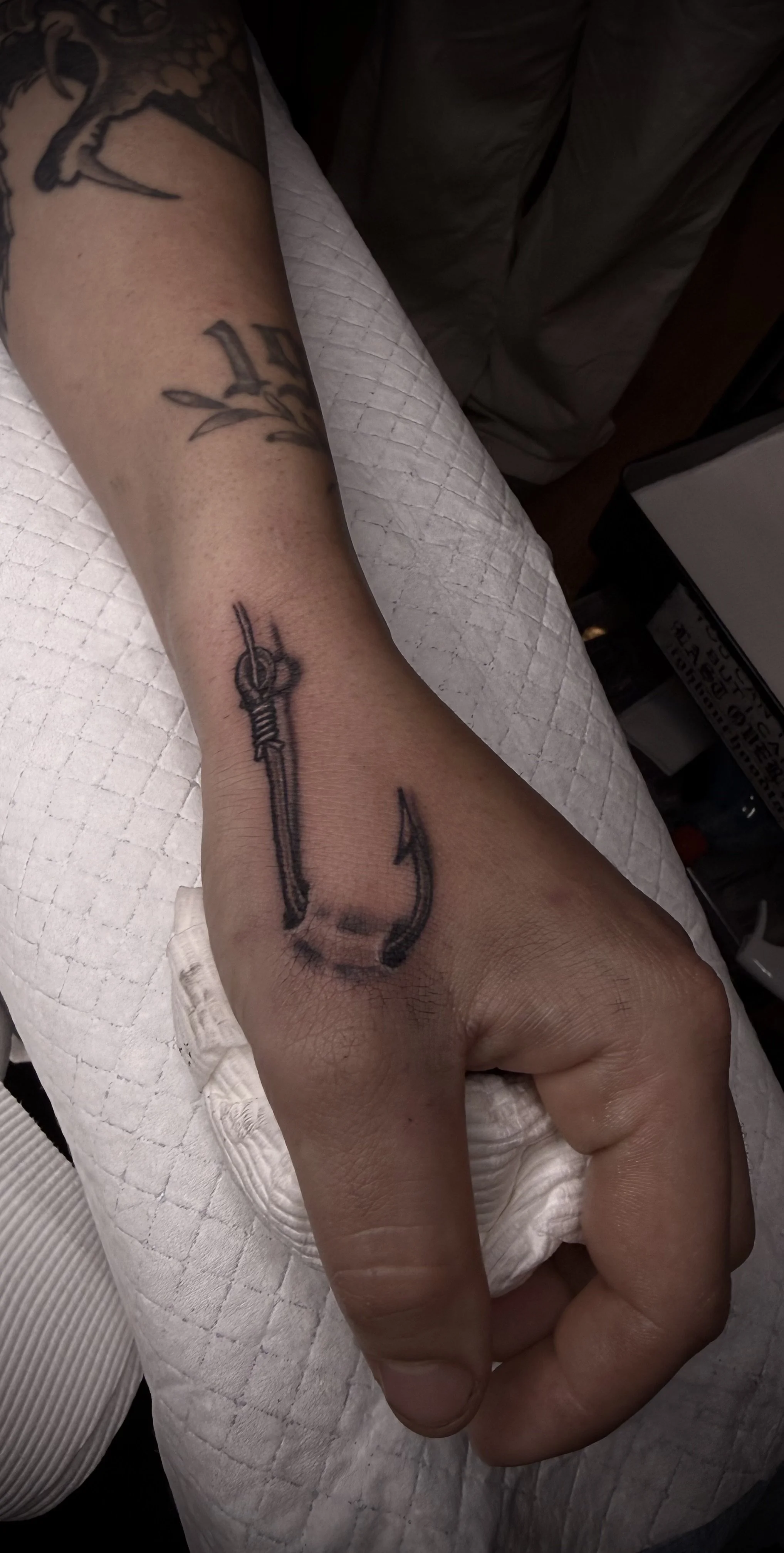 fine line fishing hook tattoo black and grey