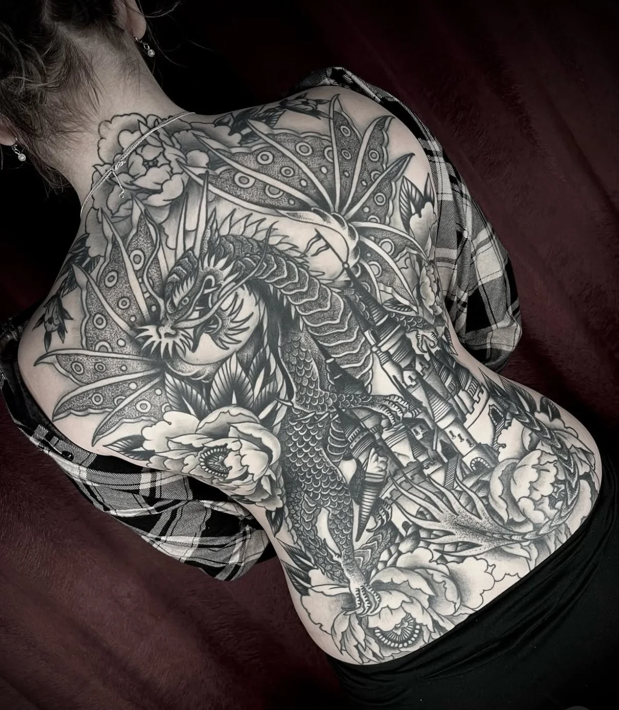 traditional back piece tattoo dragon and castle