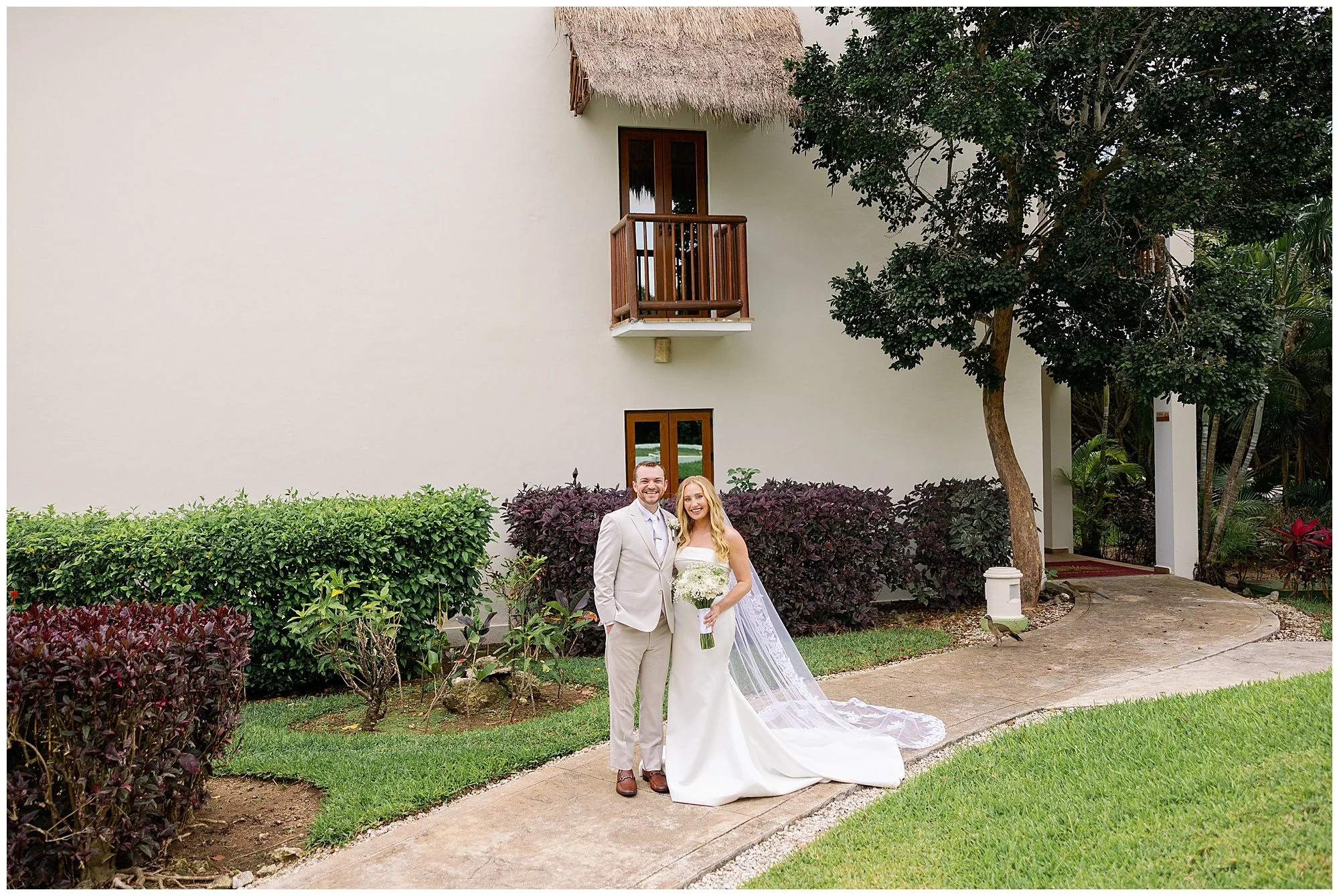  bride and groom smiling at camera at valentin imperial resort in riviera maya 