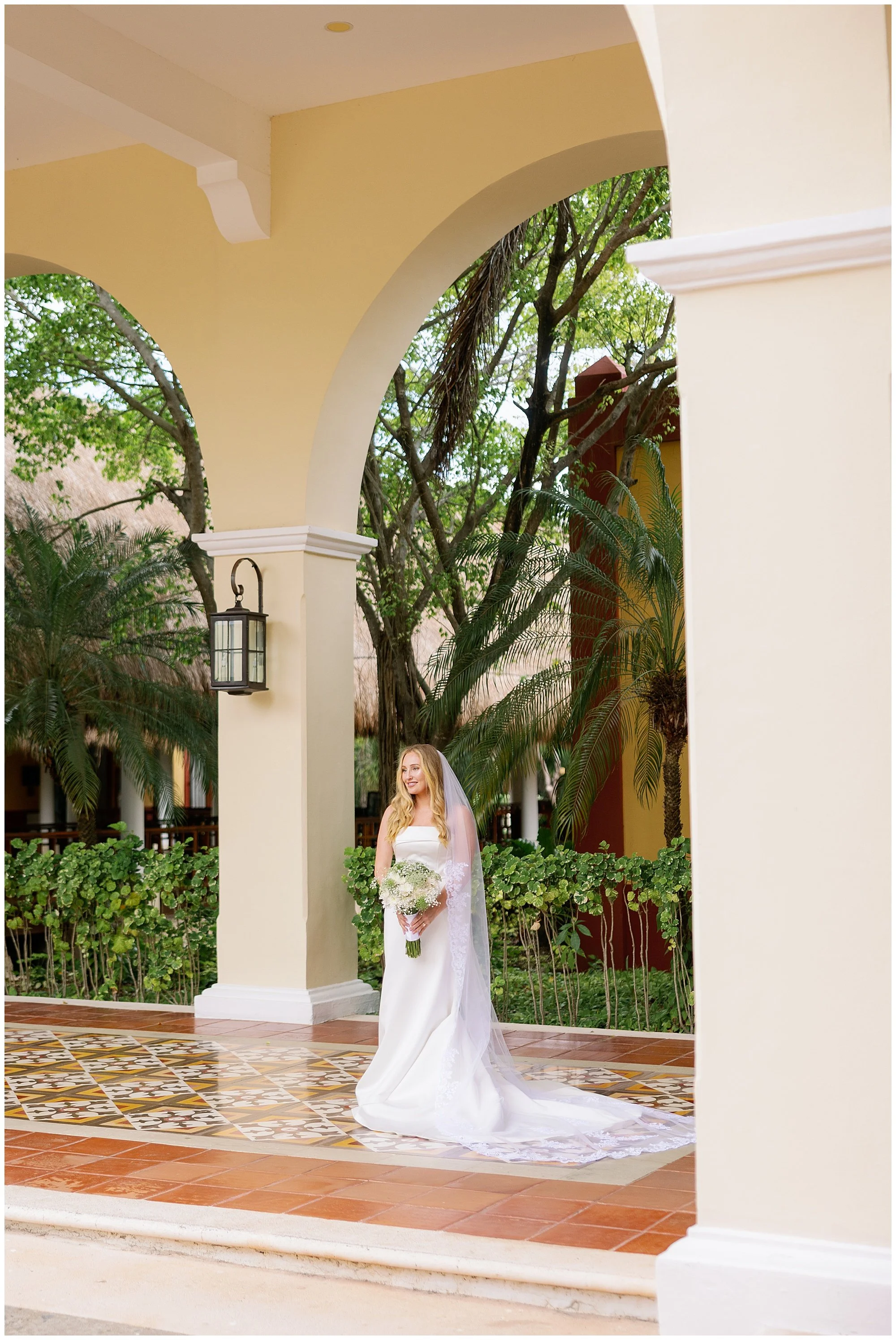  bride portrait under archway at valentin imperial resort in riviera maya 