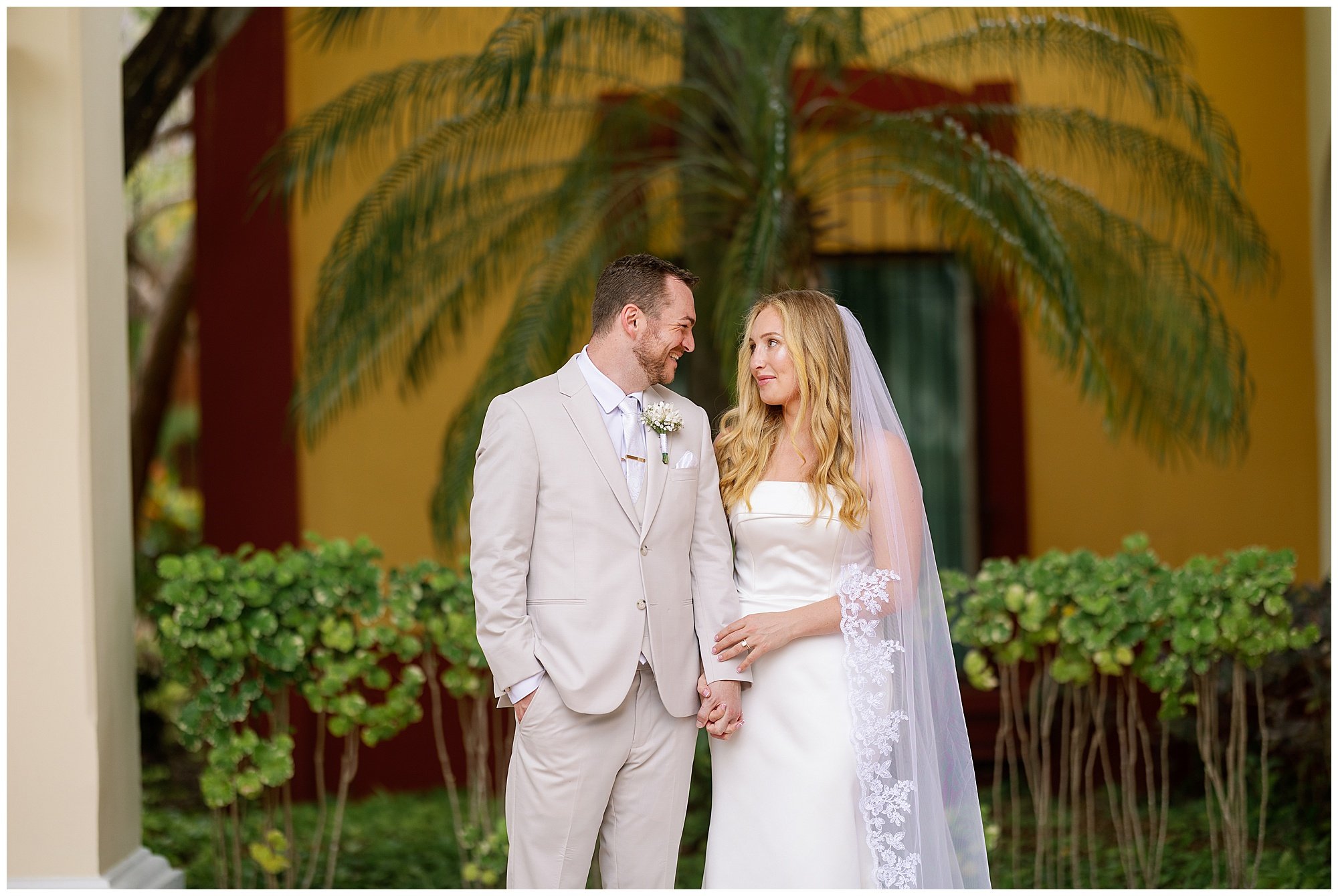  bride and groom with palm trees at valentin imperial resort in riviera maya 