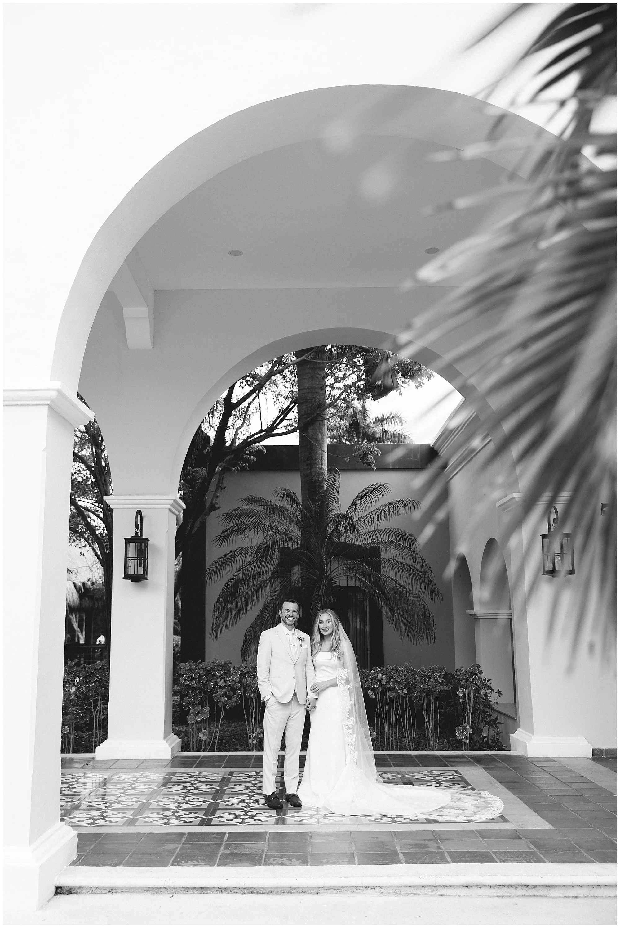  bride and groom under archway at valentin imperial resort in riviera maya 