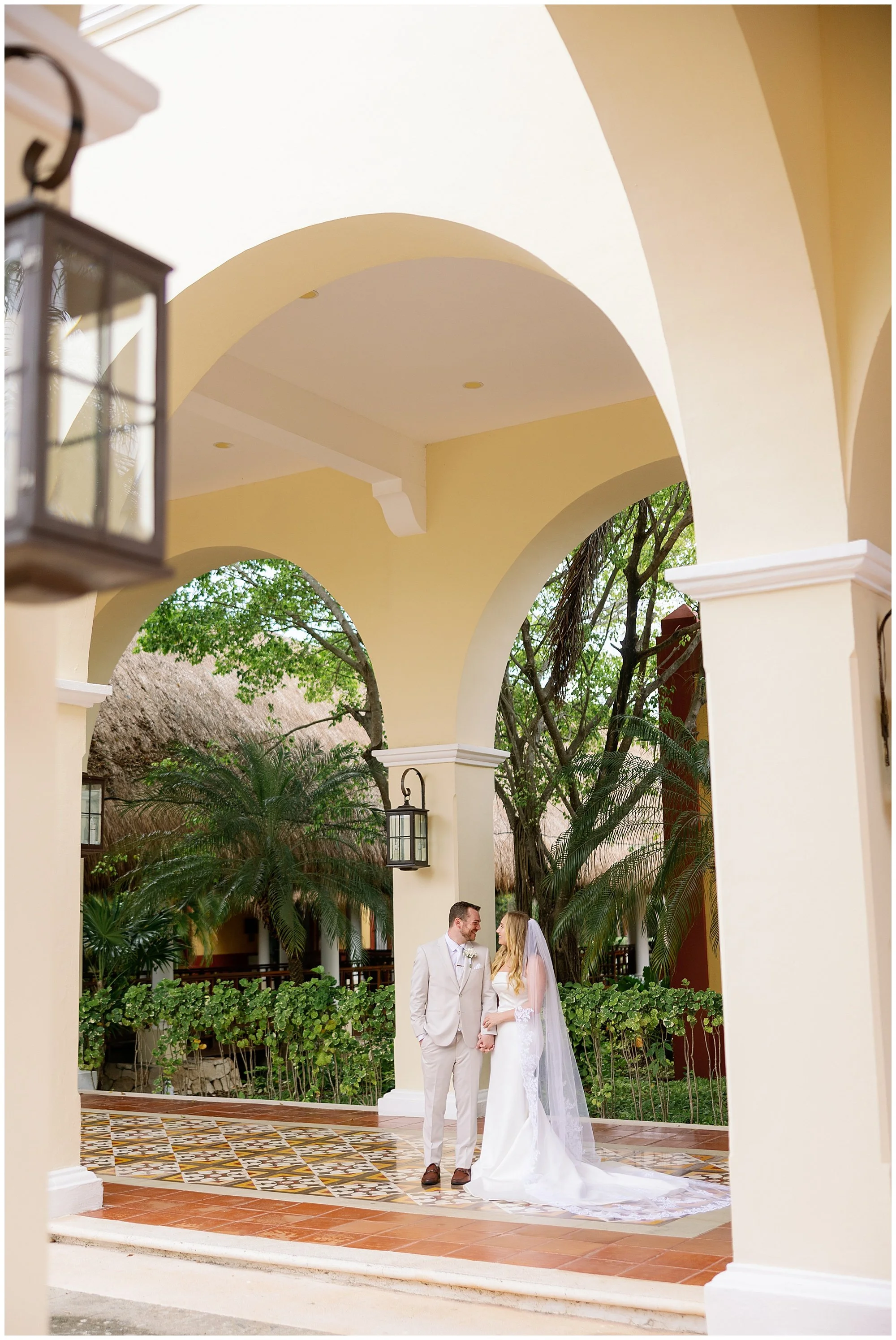  bride and groom under arch at valentin imperial resort in riviera maya 
