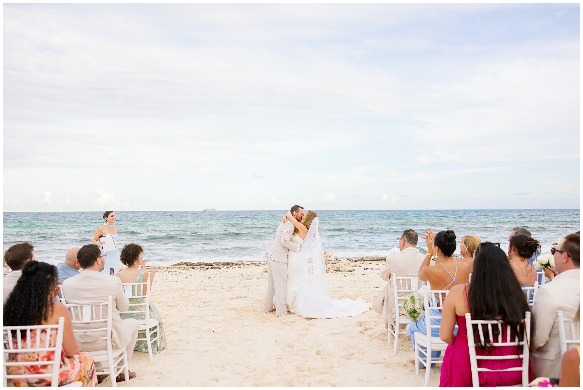  bride and groom kissing at ceremony on the beach at valentin imperial resort in riviera maya 