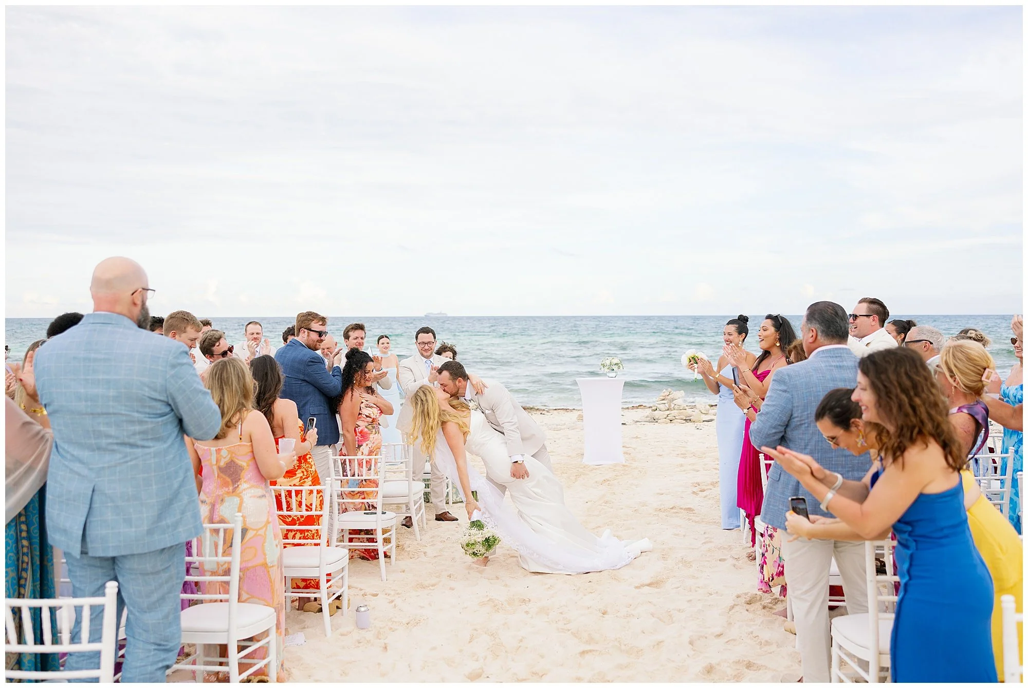  bride and groom kissing in the ceremony aisle at valentin imperial resort in riviera maya 