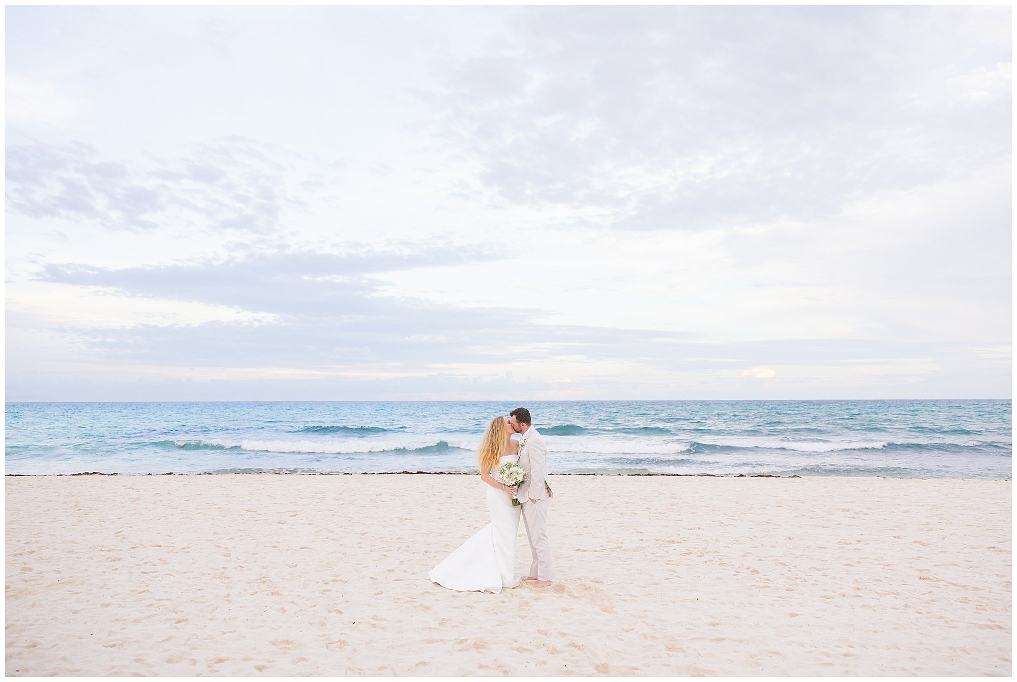  bride and groom kissing on the beach at valentin imperial resort in riviera maya 