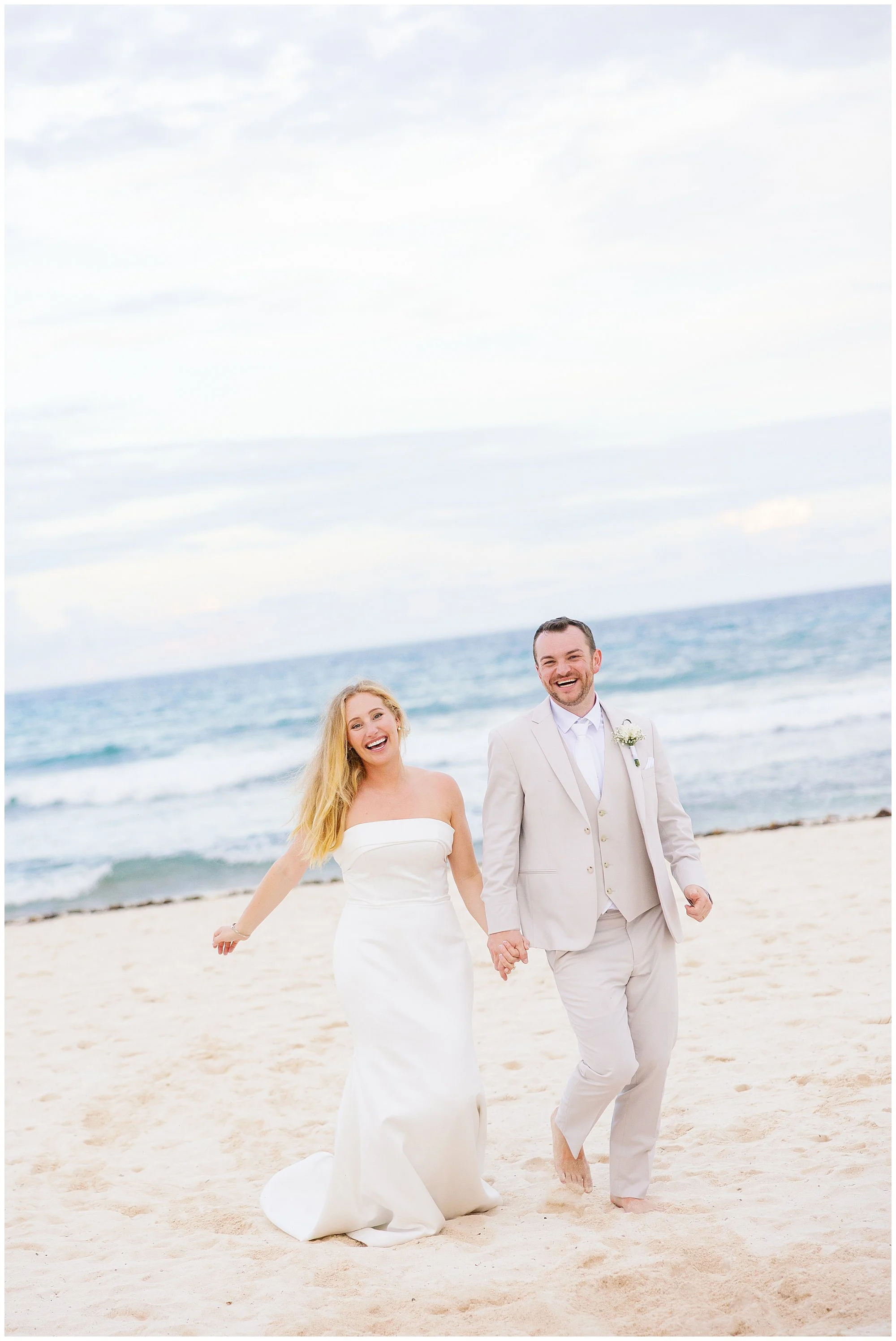  bride and groom walking on the beach at valentin imperial resort in riviera maya 