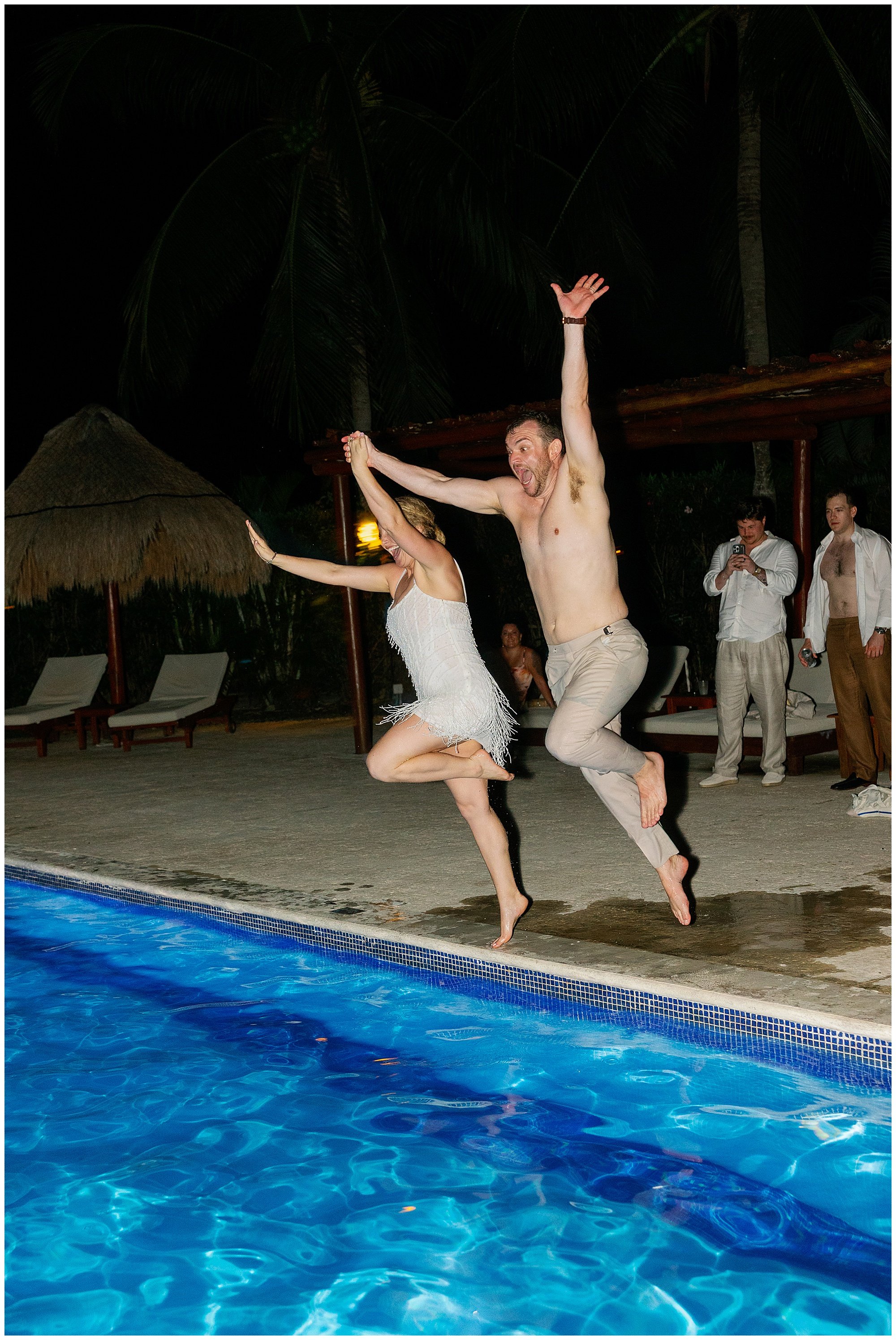  bride and groom jumping into pool after wedding at valentin imperial resort in riviera maya 