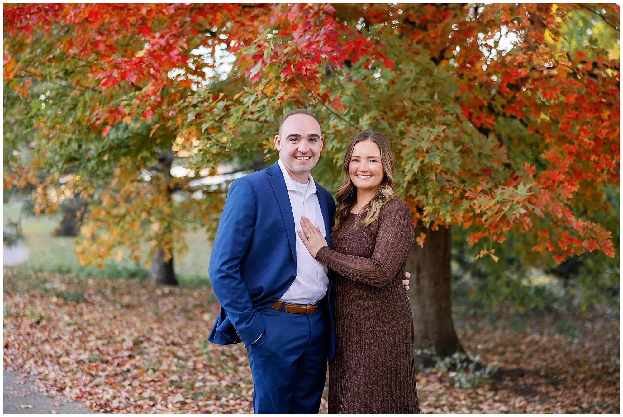  couple looking at camera in front of fall foliage at nature boardwalk in lincoln park zoo 