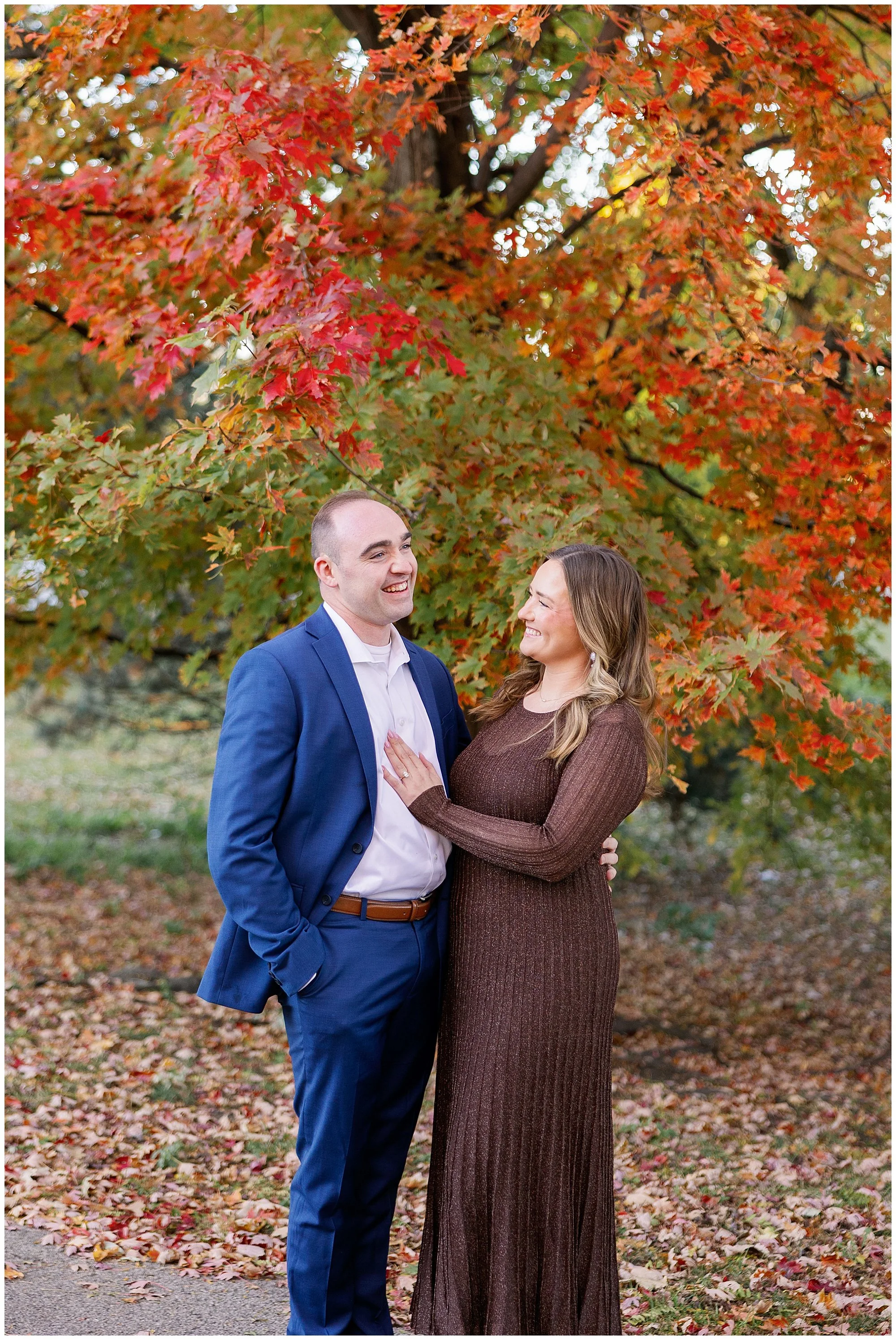  couple laughing in front of fall leaves at nature boardwalk in lincoln park zoo 