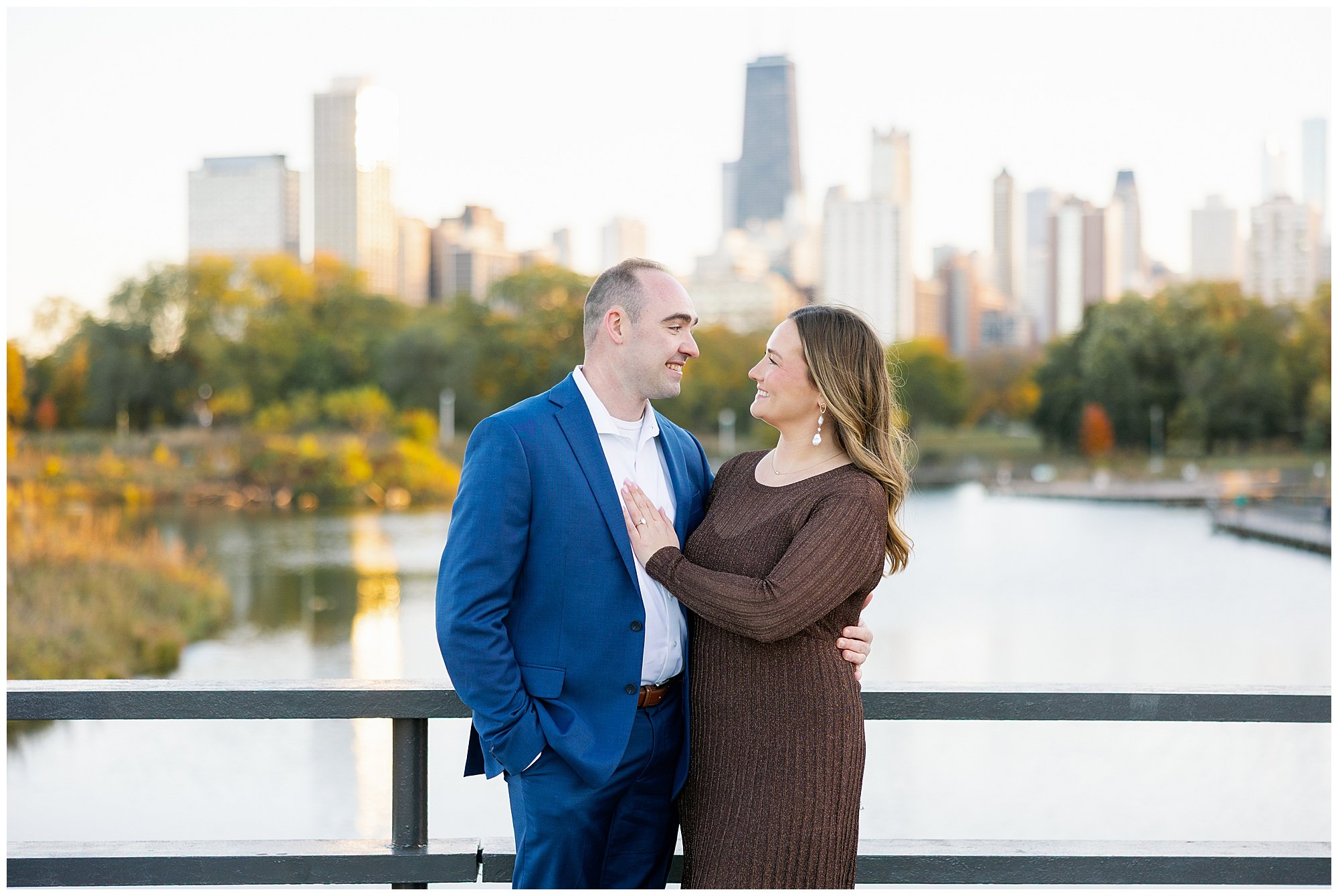  couple looking at each other in front of chicago skyline at nature boardwalk in lincoln park zoo 