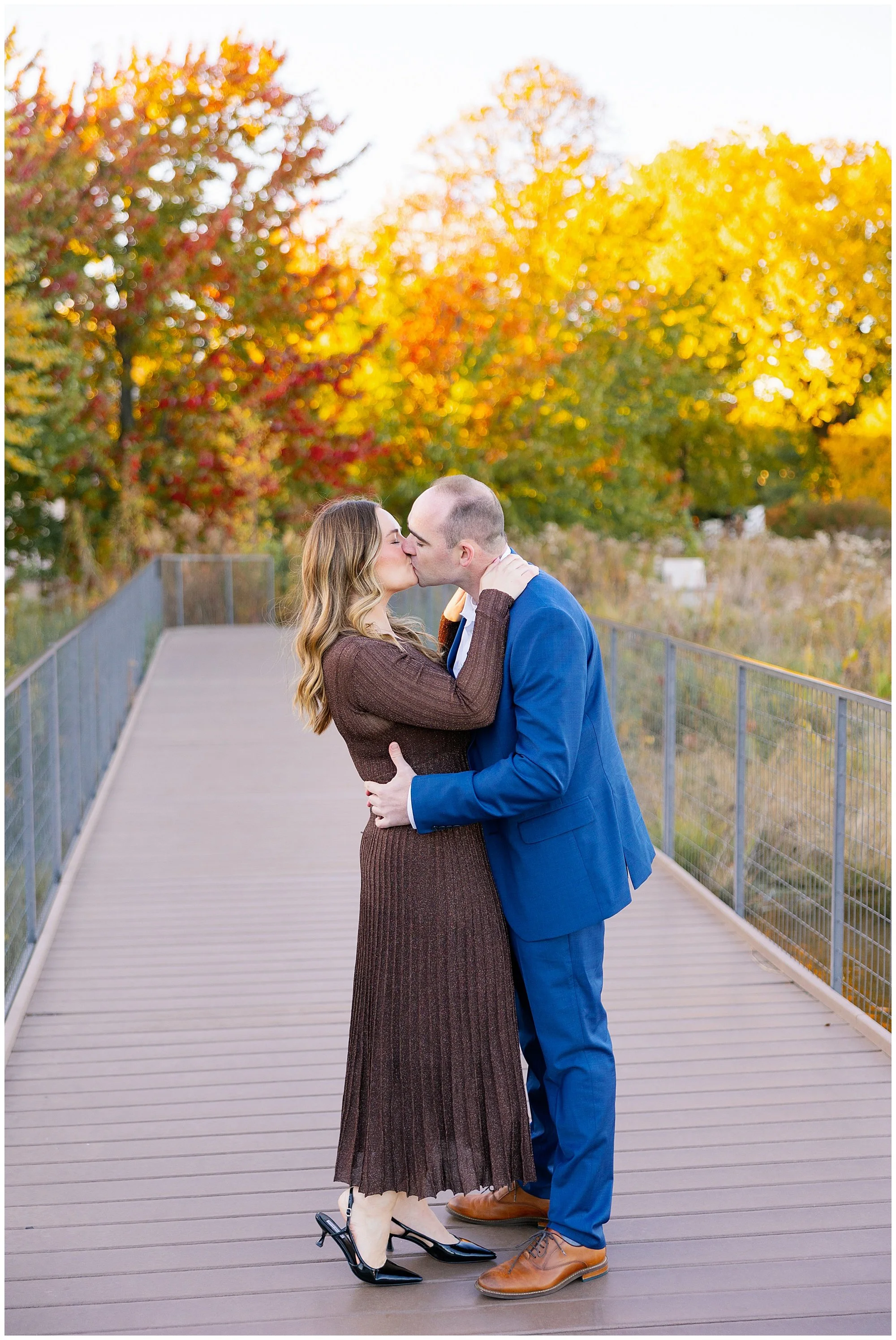  couple kissing with fall colors at nature boardwalk in lincoln park zoo 