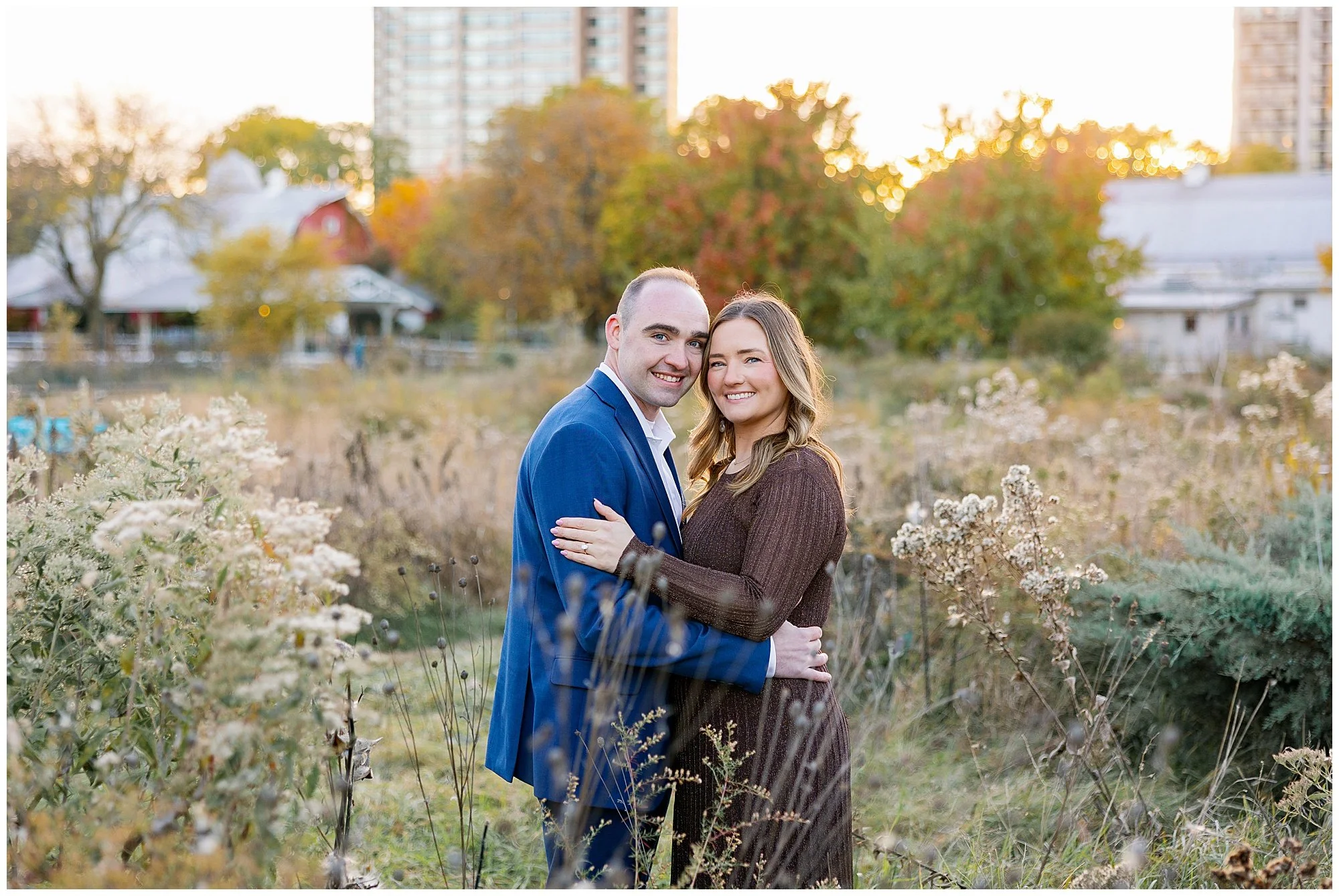  couple looking at camera in tall grass at nature boardwalk in lincoln park zoo 