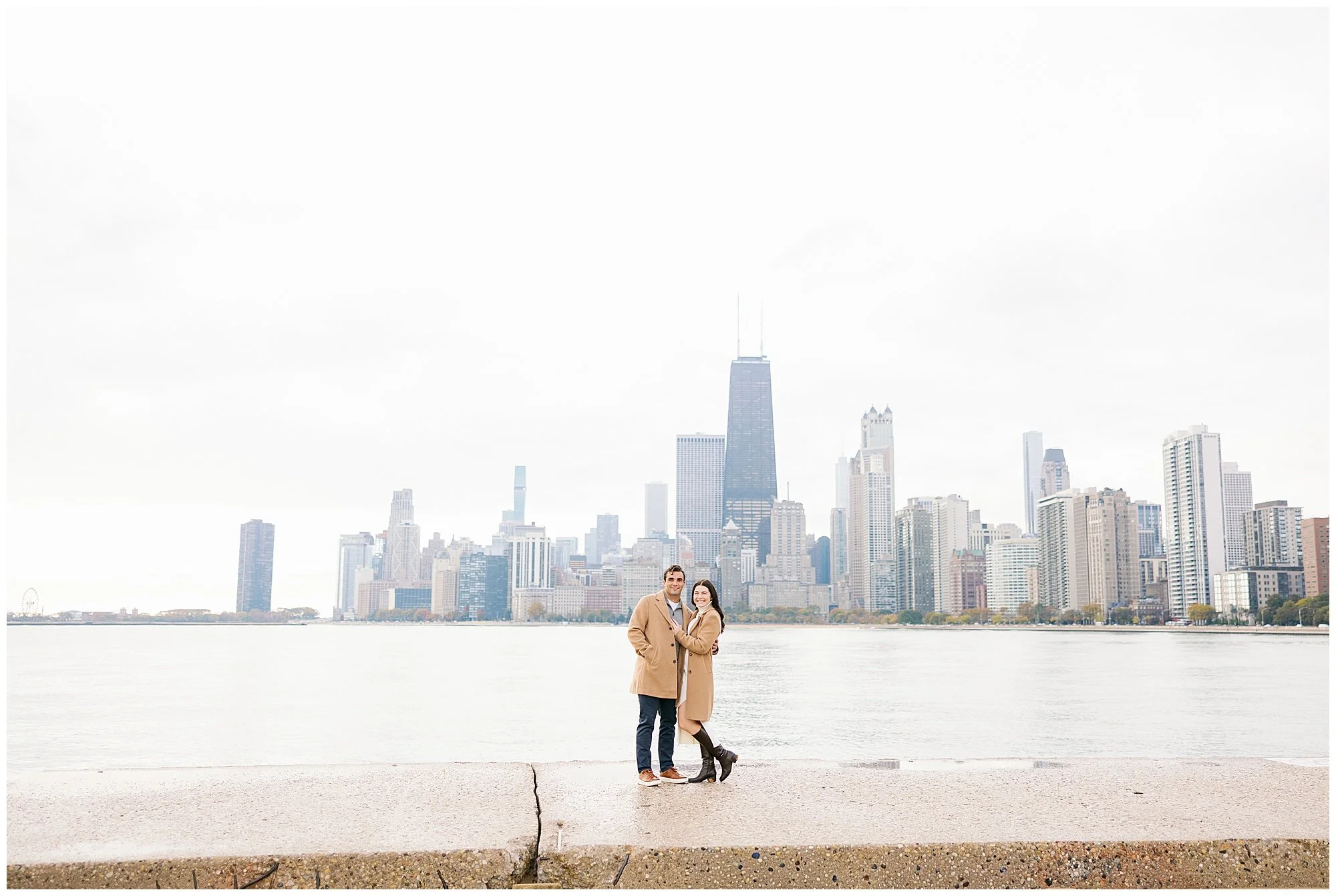  wide shot of couple in front of chicago skyline at north avenue beach 