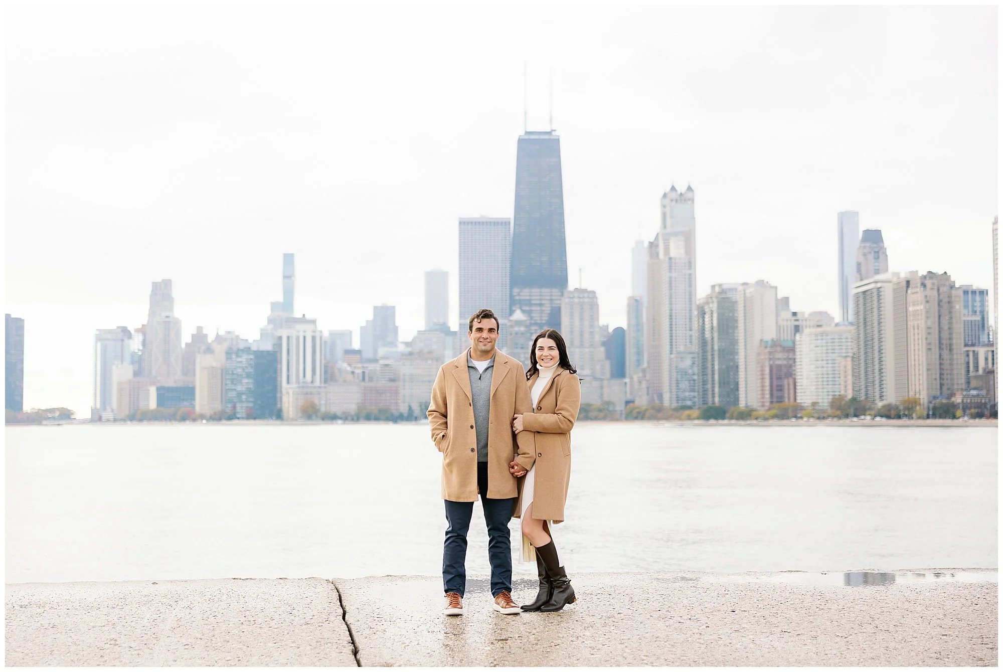  couple looking at camera in front of skyline at north avenue beach 