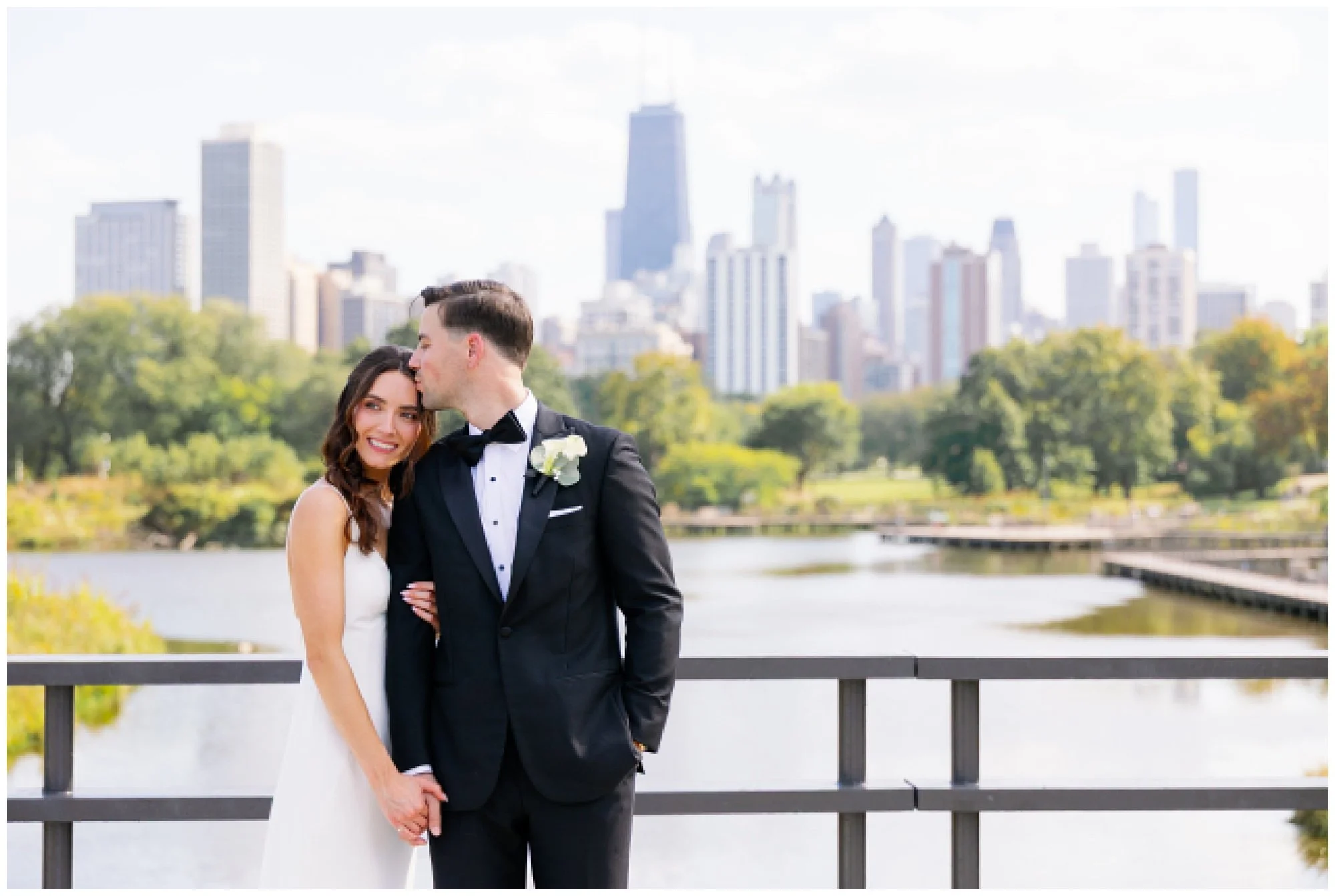  groom kissing brides forehead at lincoln park zoo south pond 