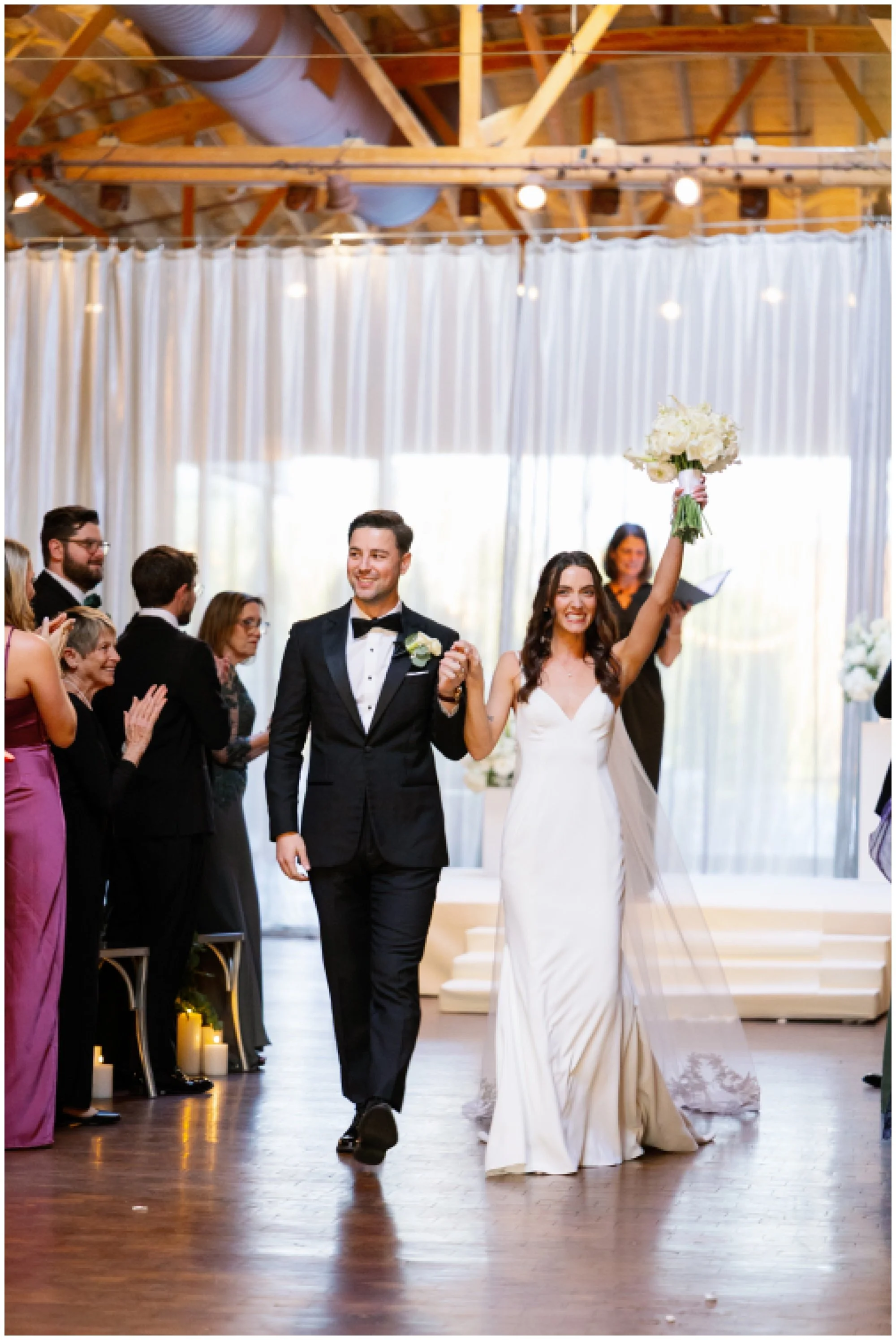  bride and groom cheering walking down aisle at rockwell on the river wedding 