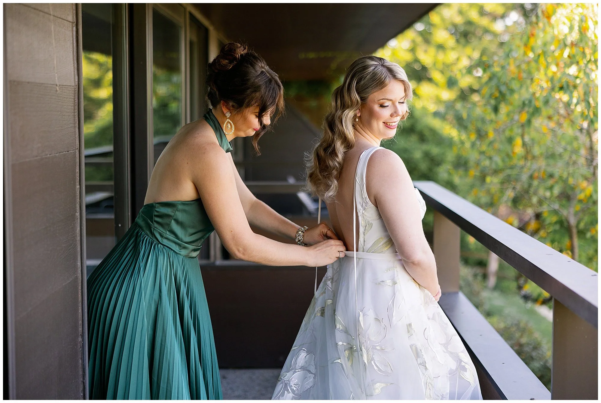  sister helping bride get into her wedding dress at grand geneva resort lake geneva wedding\ 