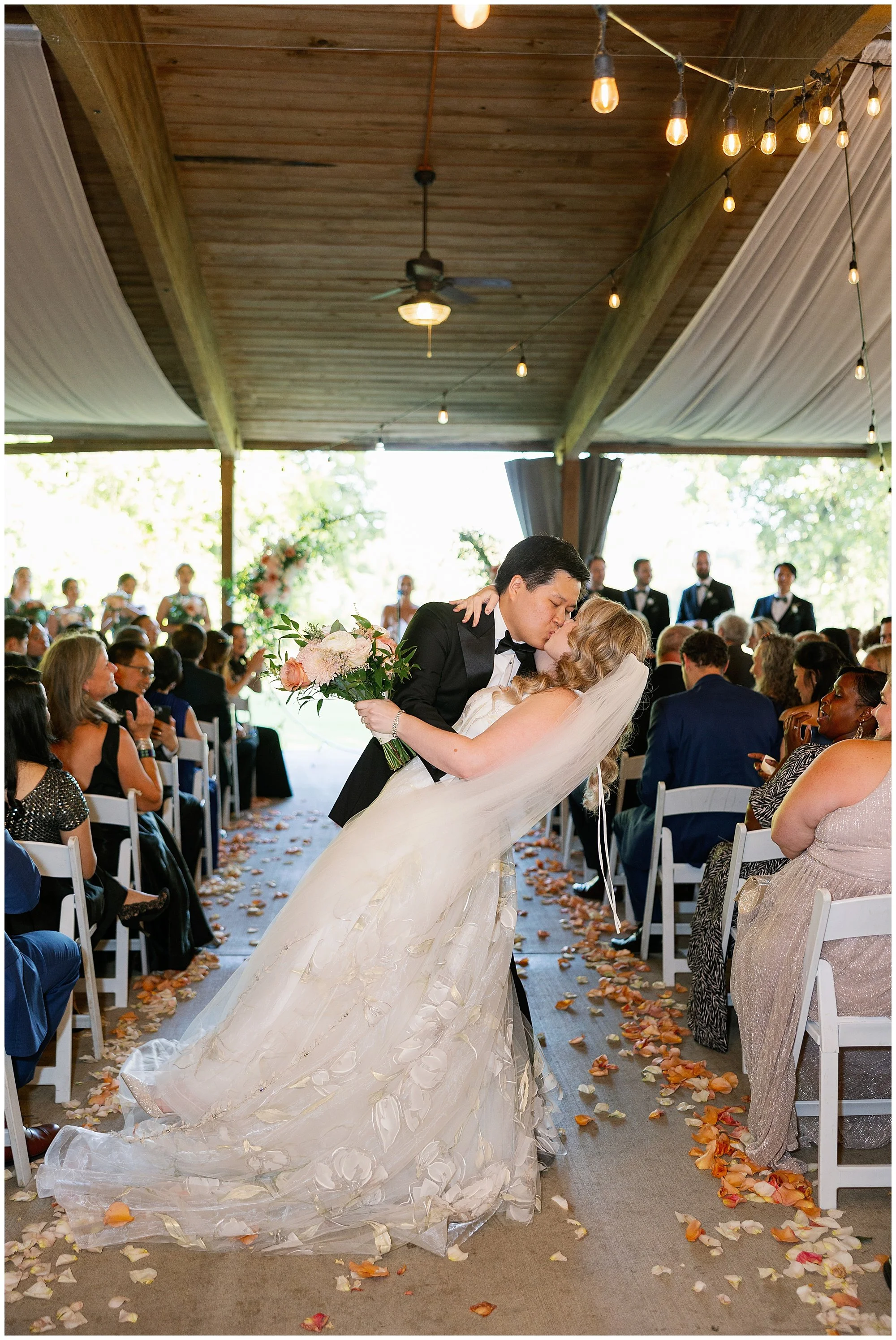  bride and groom kissing in aisle at grand geneva resort lake geneva wedding 