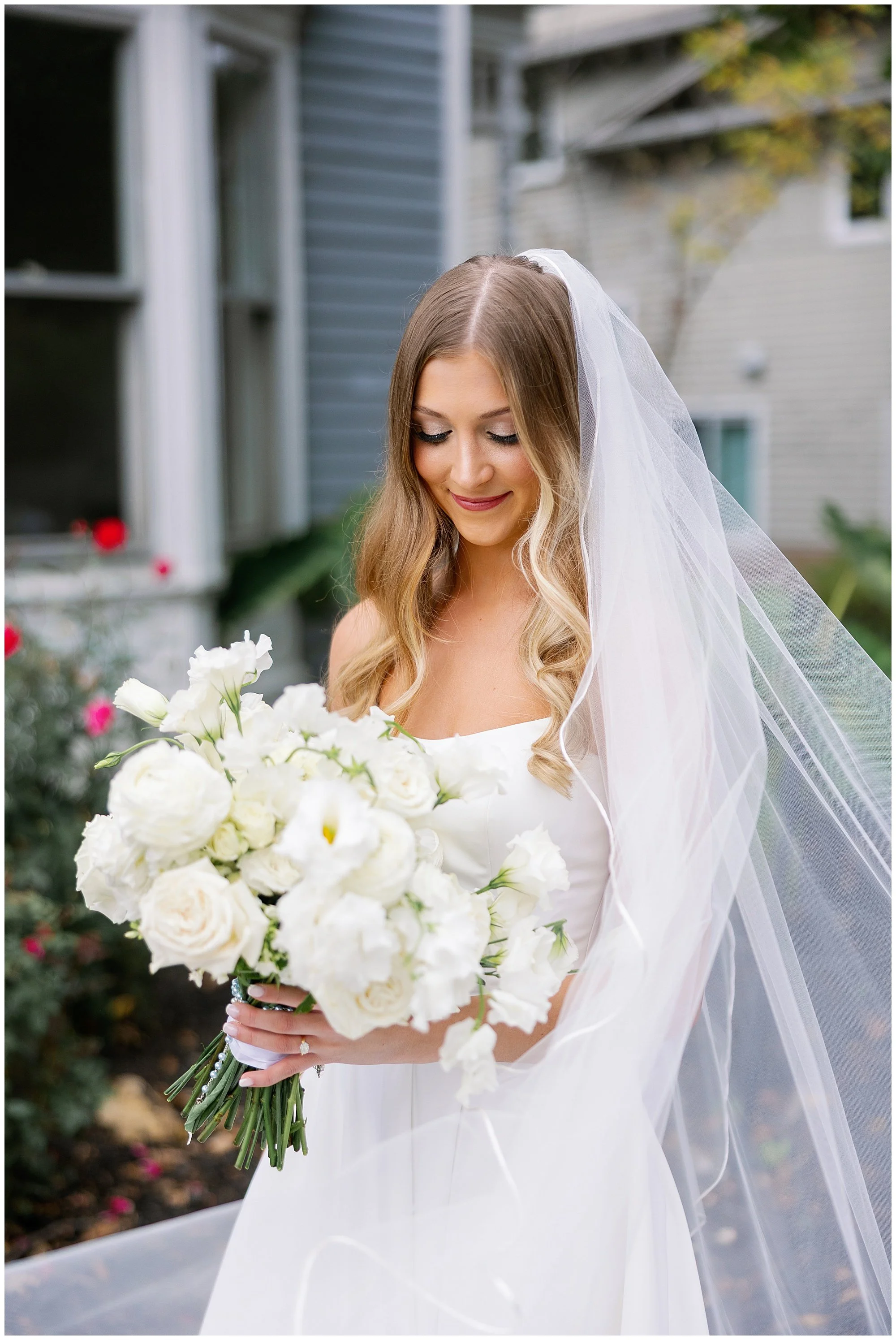  bride looking at bouquet  Mesón Sabika wedding  