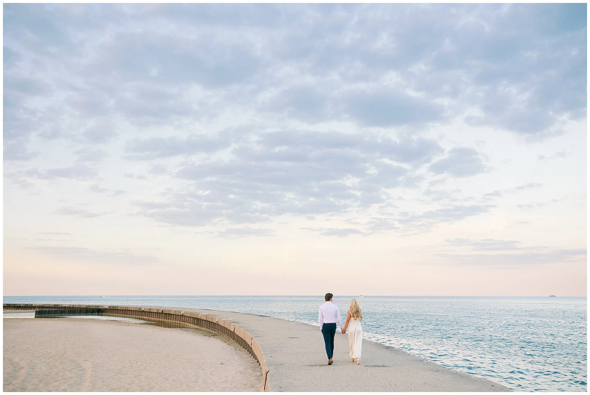  couple walking wide shot at north ave beach engagement photos 