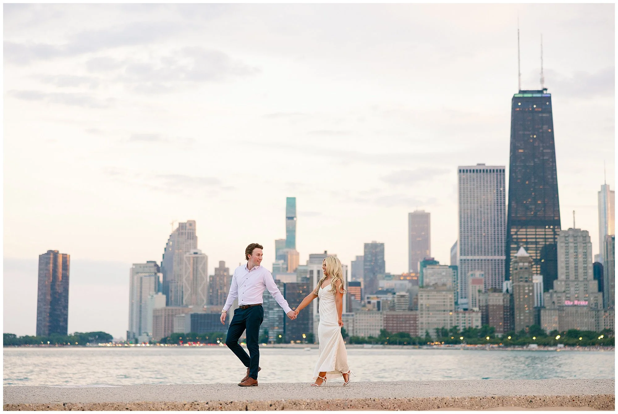  couple walking holding hands at north ave beach engagement photos 