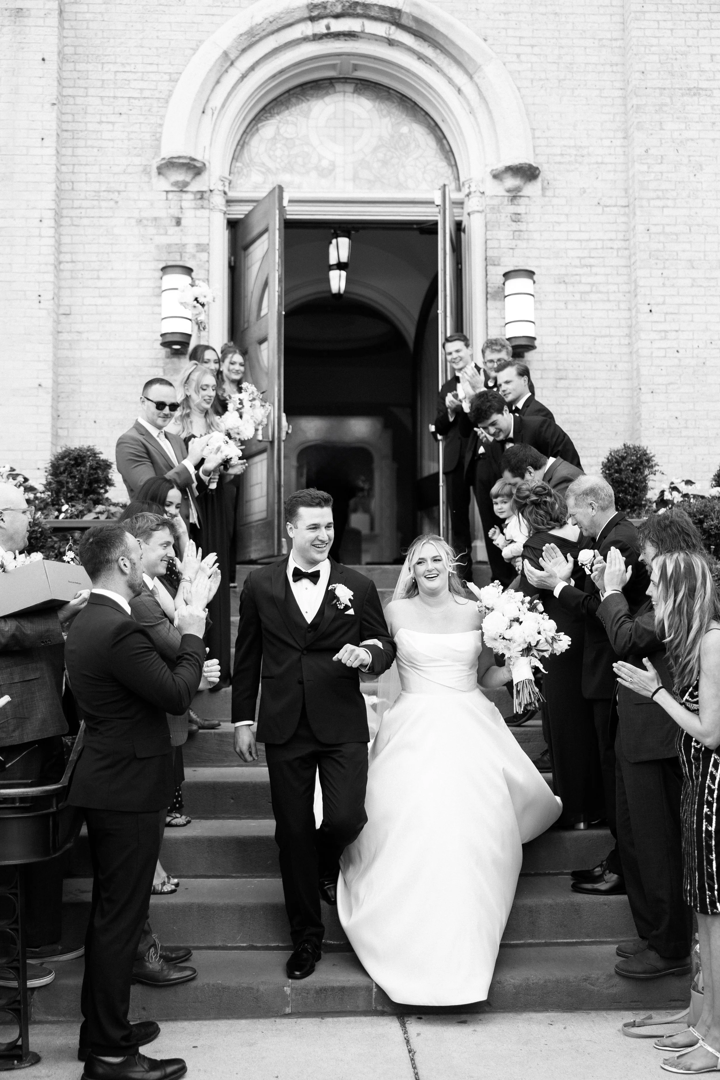 couple walking down church stairs after wedding ovation chicago