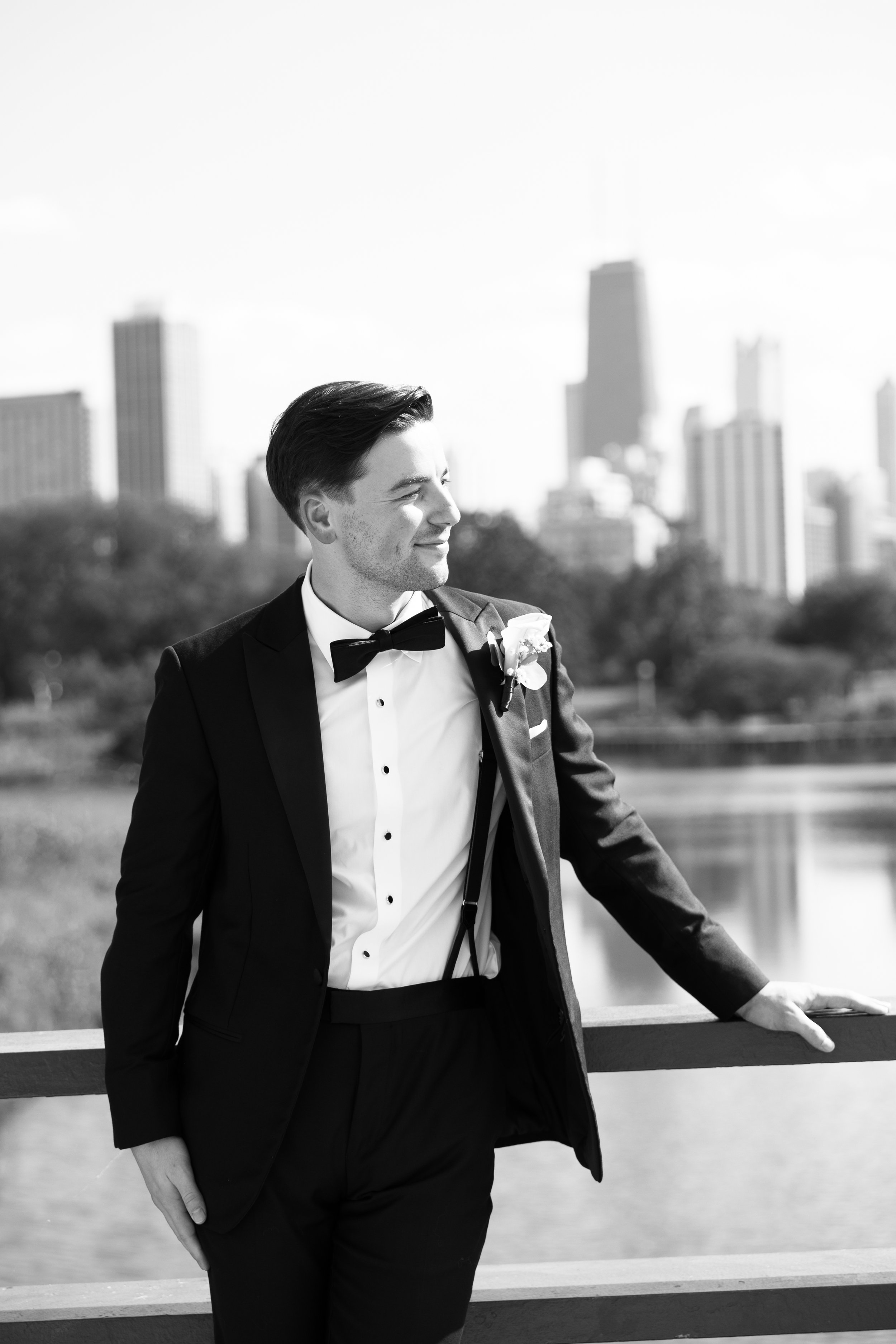groom standing on bridge lincoln park wedding