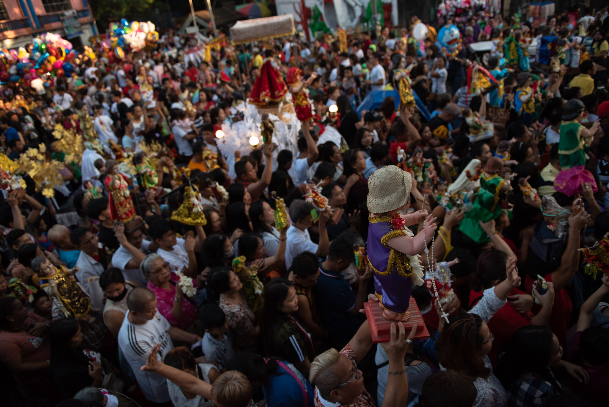  A huge crowd of devotees with images over their heads from outside the church. 