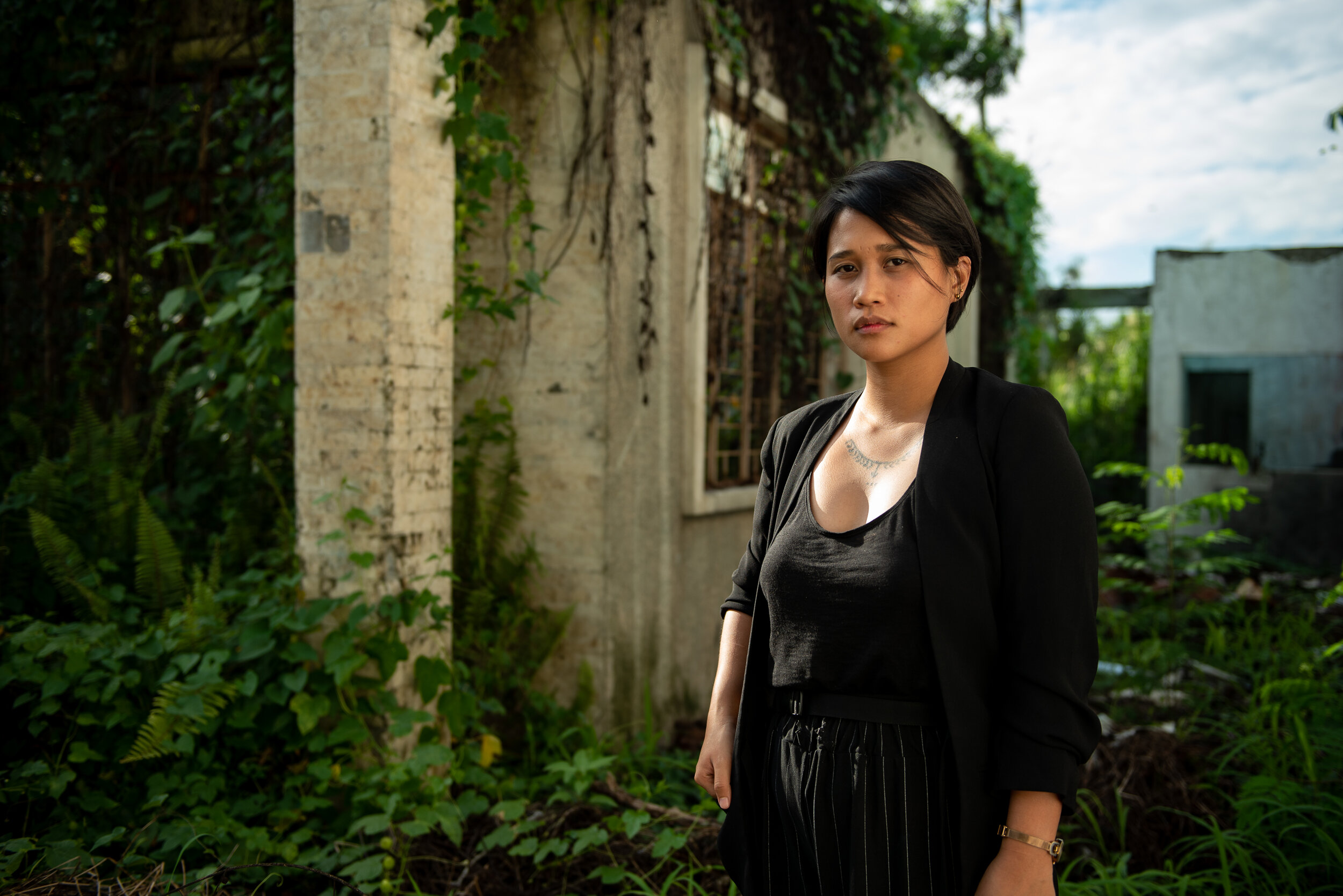  Joanna photographed standing outside of her seaside bungalow home damaged by typhoon Haiyan six years ago. Joanna lost her parents and eldest brother to the typhoon, which took the life of 6,000 others. 