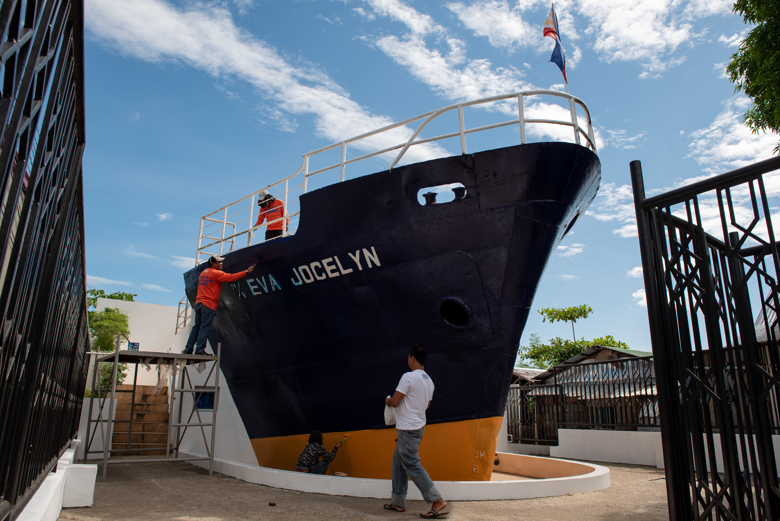  Workers repaint the M/V Eva Jocelyn, a ship that was washed ashore during the Typhoon Haiyan and now serves as a Yolanda Shrine. 