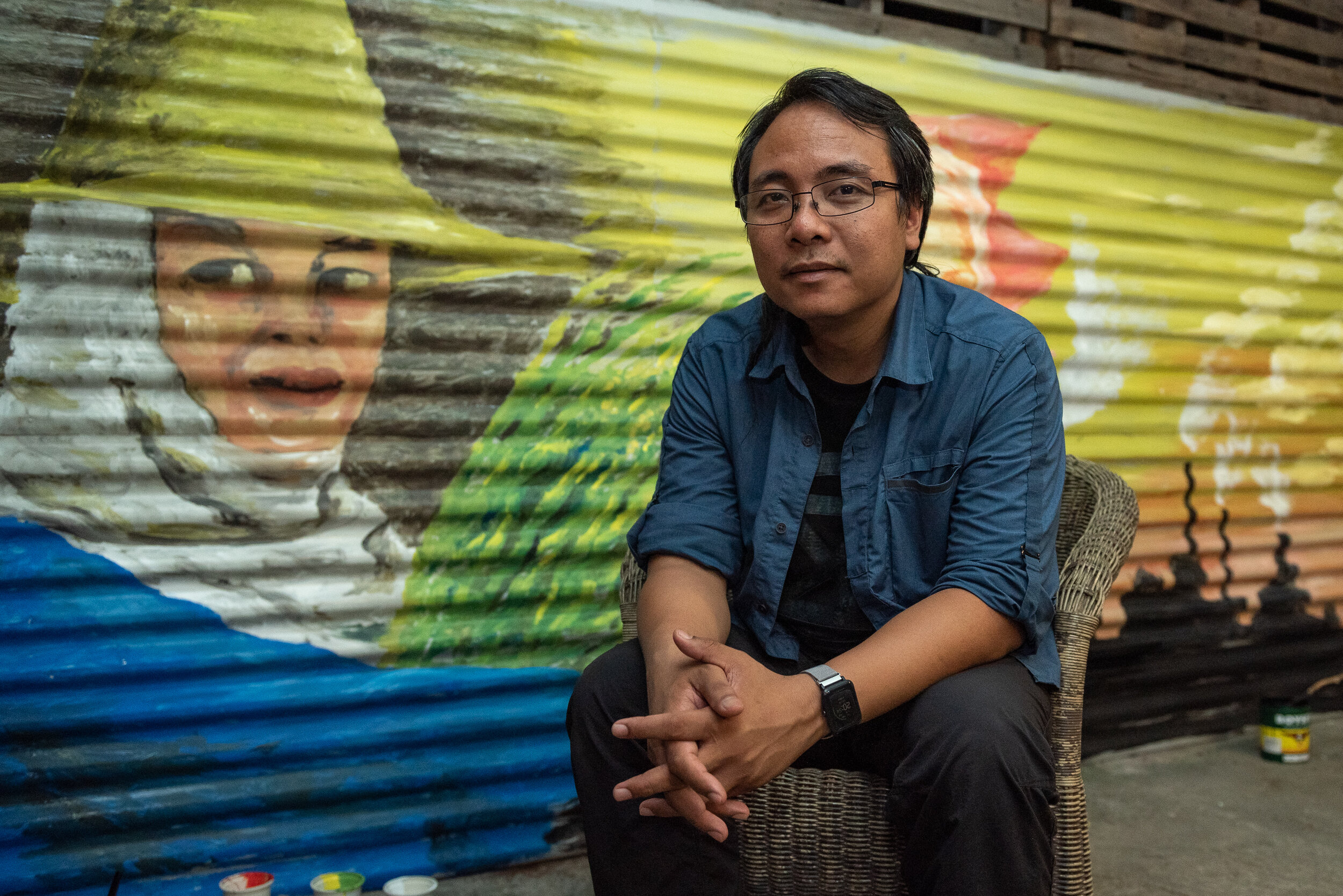  Greenpeace Southeast Asia Executive Director Naderev "Yeb" Sano poses in front of an unfinished mural painting about climate change. A distinguished negotiator at climate change conferences all over the world, Yeb is well-known for his initiative to